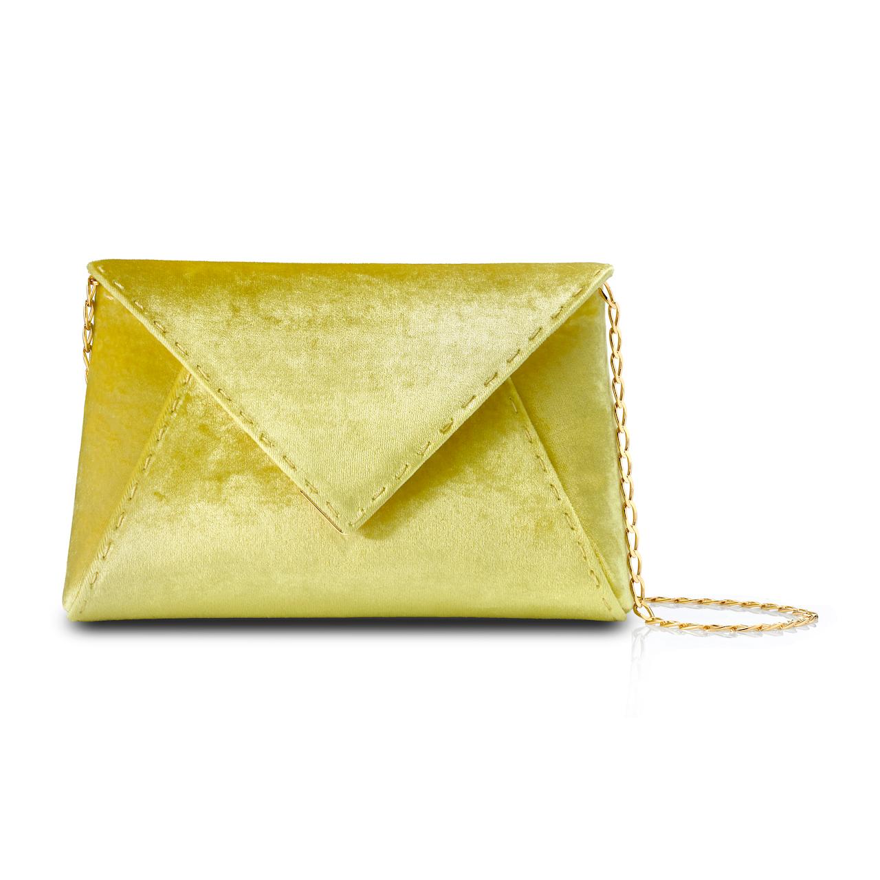 The Lee Pouchet Small Clutch is featured in our Limoncello crushed velvet with gold hardware. The envelope-shaped clutch is designed with a triangular front flap and a magnetic snap closure. The exterior detailing is entirely hand-stitched. The Lee