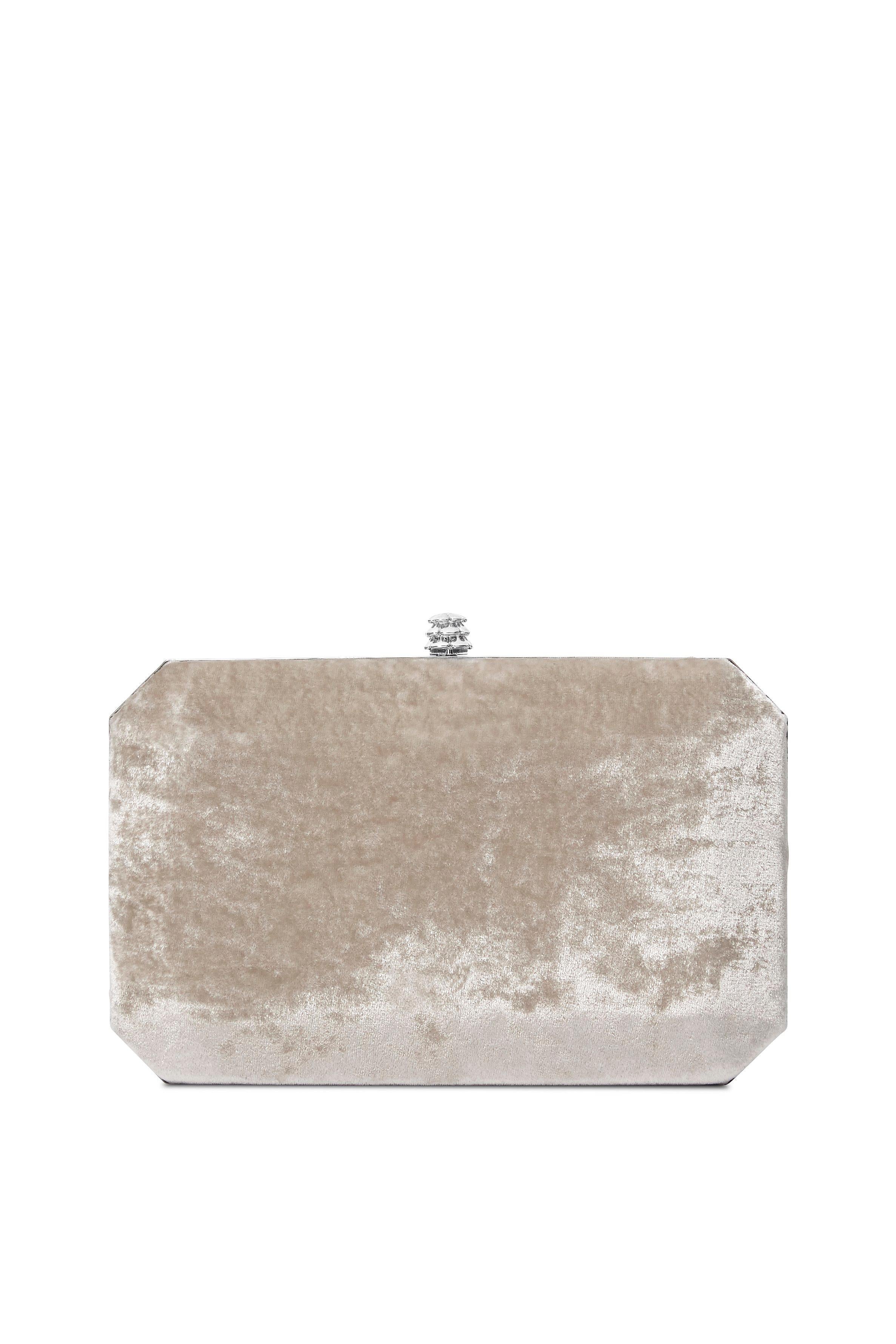 The Lily is featured in our Platinum crushed velvet with silver hardware. It is a hard-framed rectangular clutch designed with interior pockets and an optional silver cross-body chain. It fits the large iPhone and features our signature Pinecone