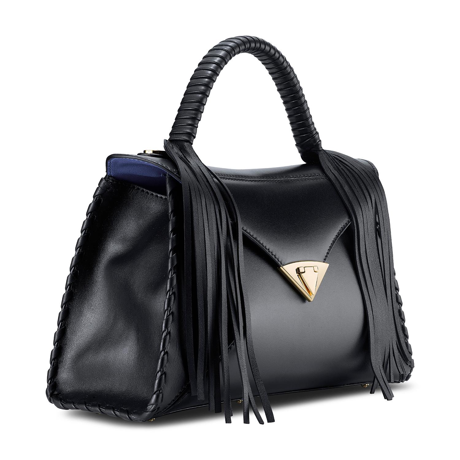The LJ in Black Leather Gold Hardware is a semi-structured handbag with a triangular front-flap and our custom spear-lock closure. It is designed with a top-handle, handmade whipstitch detail and an optional chain. It has a hidden back pocket,