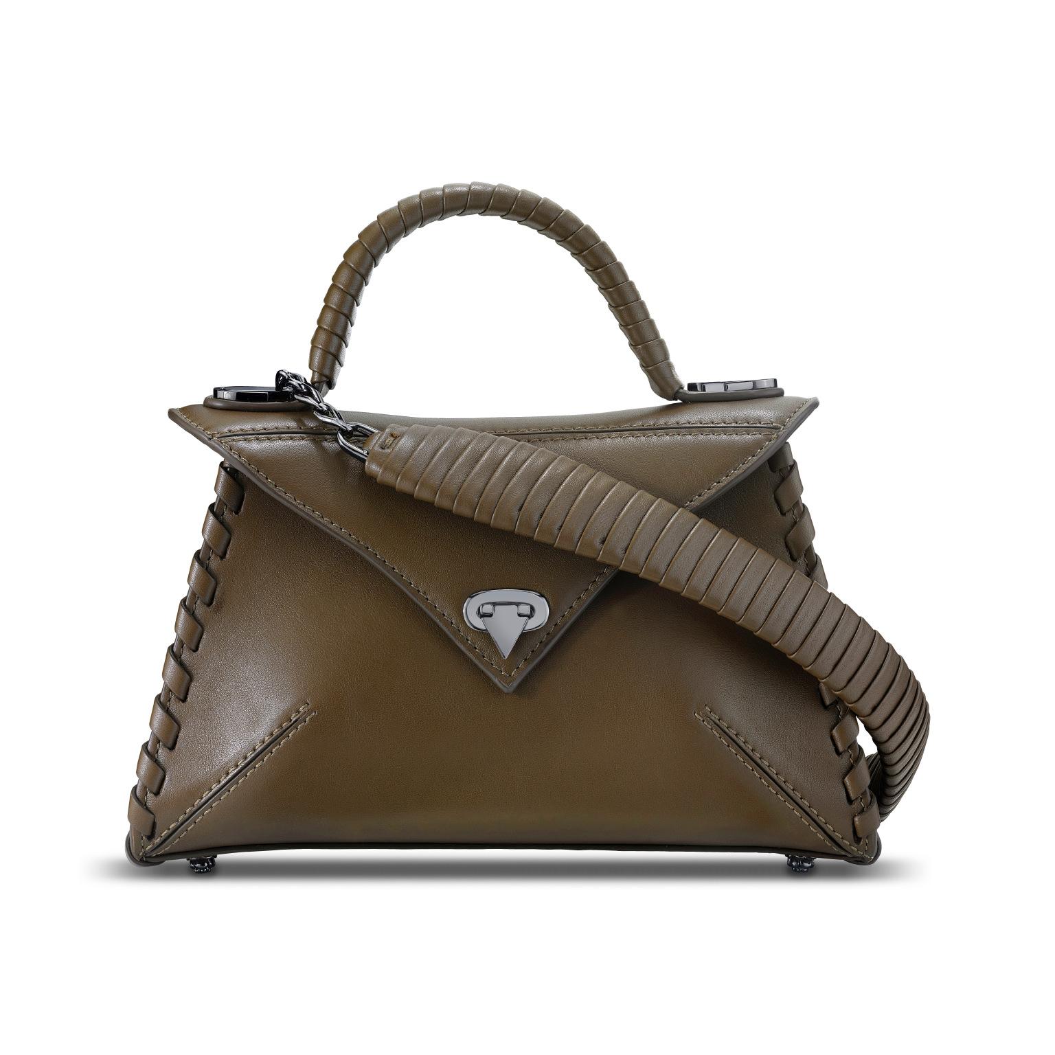 The LJ is featured in Truffle Leather with gunmetal hardware. This semi-structured handbag has a triangular front-flap and our custom Spear-lock Closure. It is designed with a leather-wrapped top-handle, handmade “whip-stitch” detail and an optional