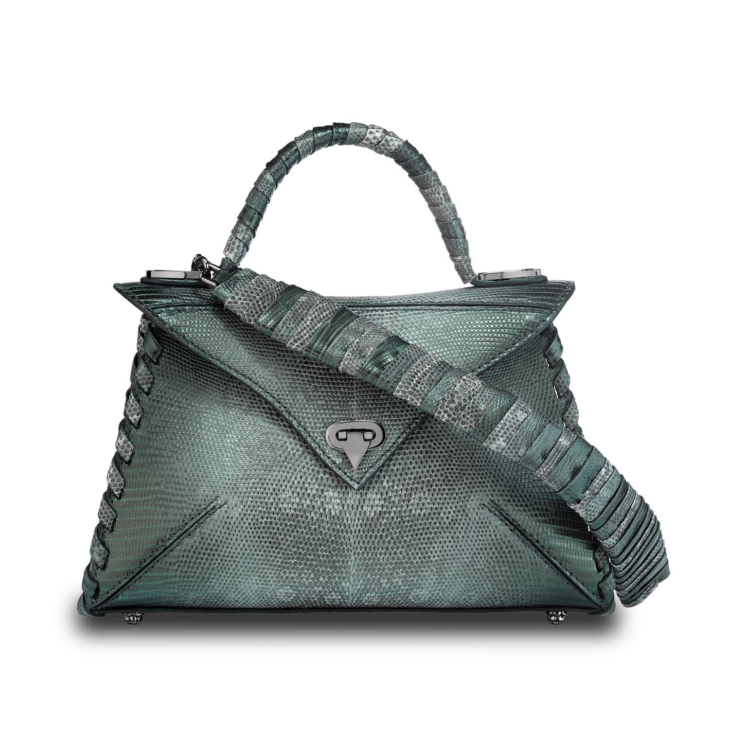 The LJ handbag small is featured in Peacock Lizard with gunmetal hardware. This semi-structured handbag has a triangular front-flap with our custom Spear-lock Closure. It is designed with a lizard-wrapped top-handle, handmade “whip-stitch” detail