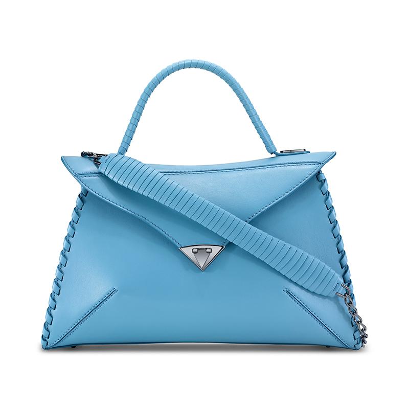 The LJ in Santorini Blue is a semi-structured handbag with a triangular front-flap and our custom Spear-lock Closure. It is designed with a leather-wrapped top-handle, handmade “whip-stitch” detail and an optional gunmetal chain with a