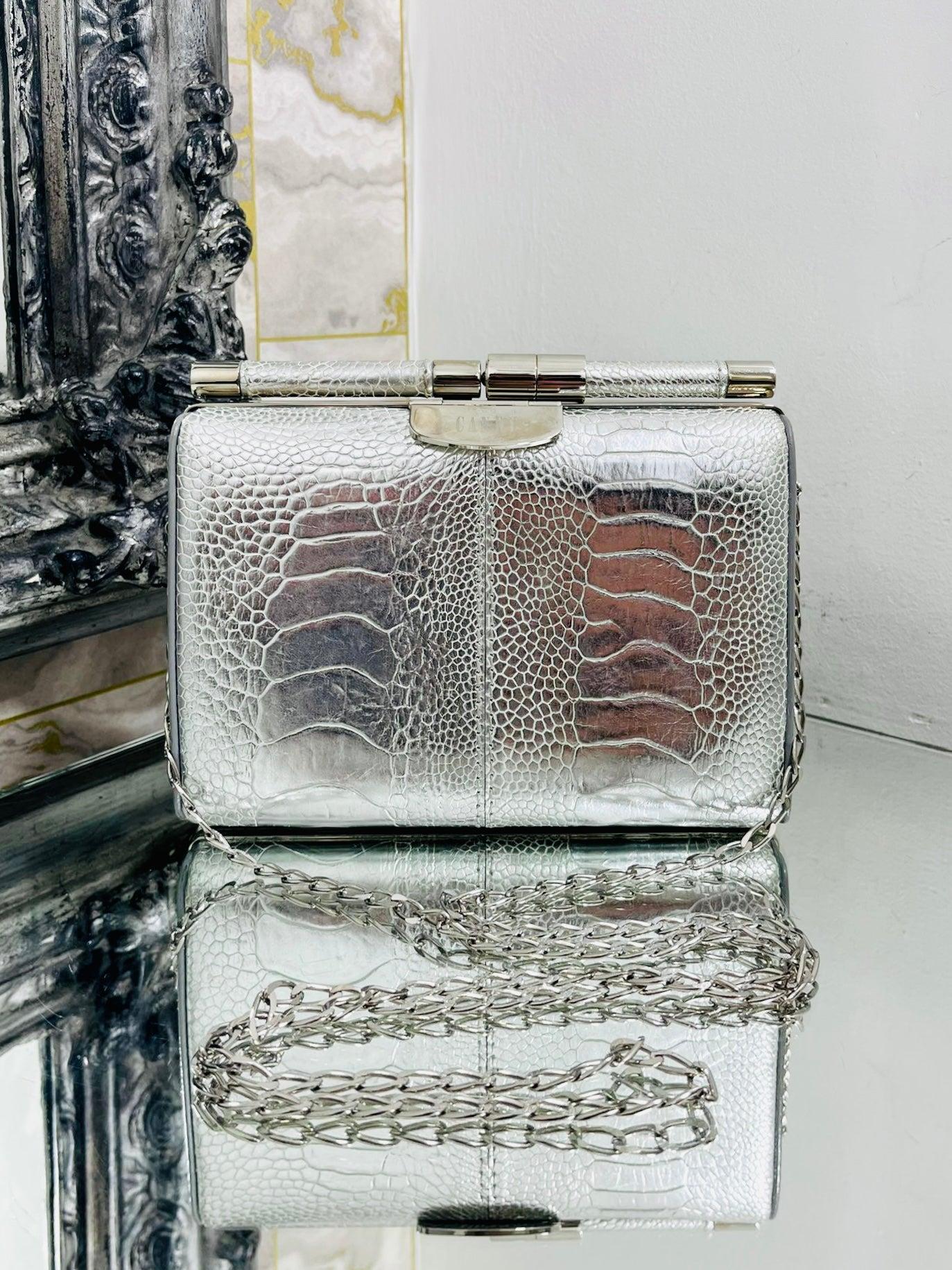 Tyler Ellis Metallic  Lizard Skin Clutch Bag With Chain Strap

Metallic shiny silver , structured 'Jamie' evening bag in exotic leather.

Detailed with silver hardware which has been personalised with 'Candy' lettering.

Featuring detachable