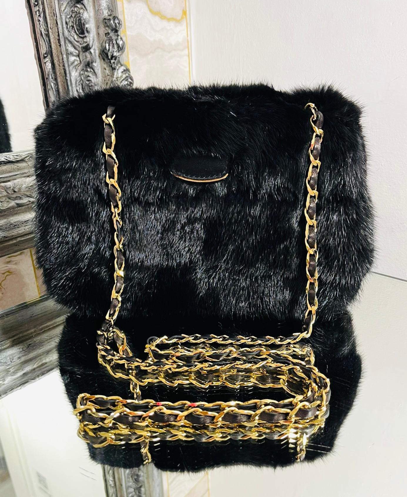 Tyler Ellis Mink Fur Clutch Bag With Leather & Chain Strap

Black structured fur bag designed with gold chain and leather, thin shoulder strap.

Featuring front flap closure leading to bright blue interior.

Size – Height 19cm, Width 27cm, Depth