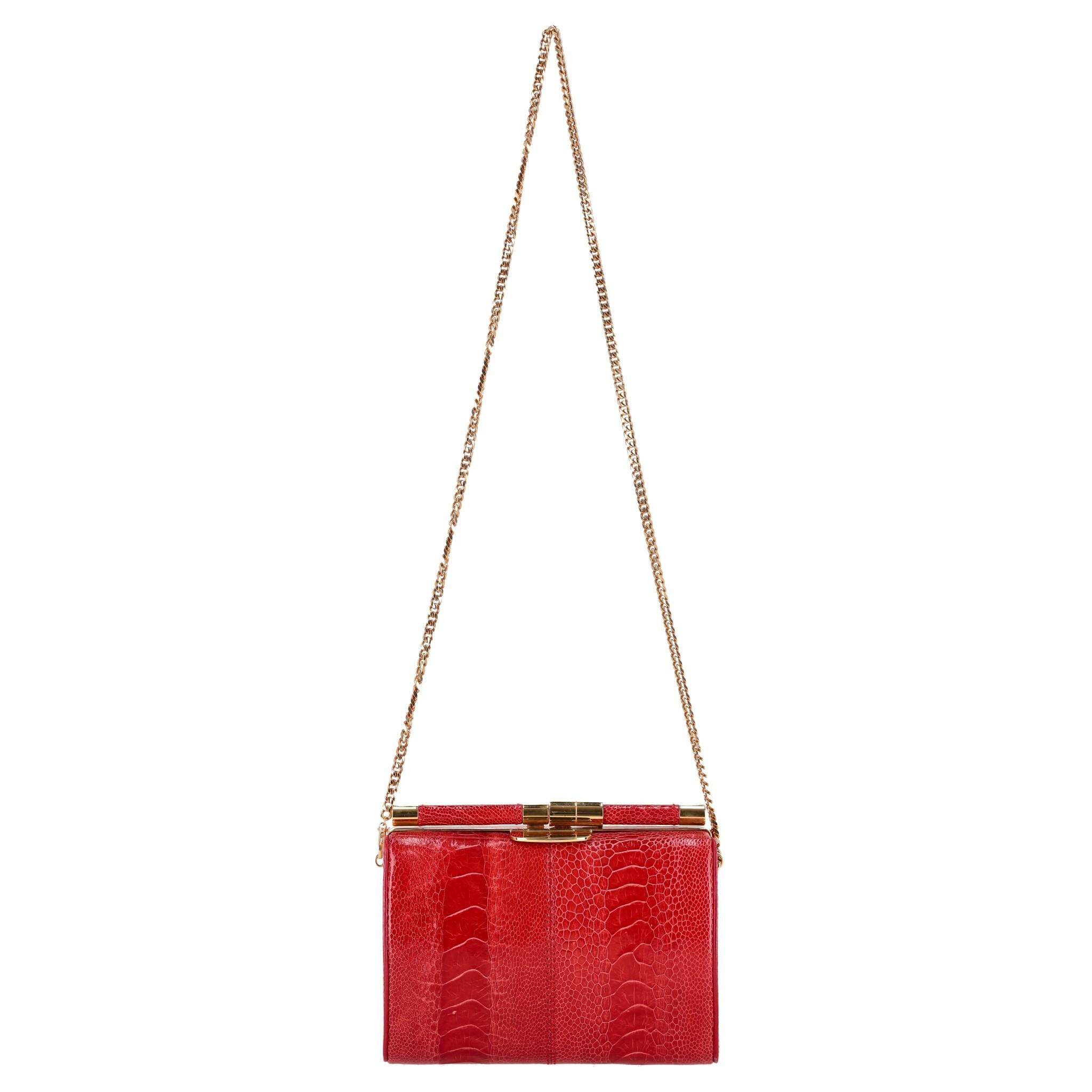 Tyler Ellis Ostrich Skin Clutch Bag With Chain Strap

Red 'Anjuli' evening bag crafted from exotic leather in structured-oval shape.

Featuring gold hardware and removable chain-link shoulder strap.

Bright blue satin interior with gold branded