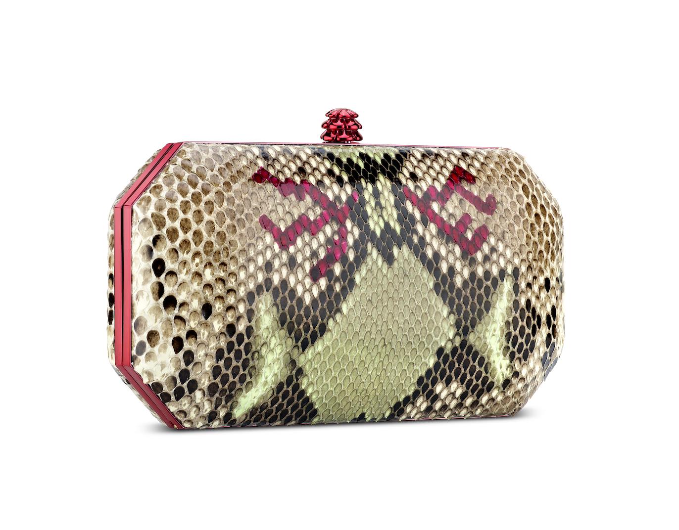 The Perry in Carnival Natural Python is a hard-framed clutch designed with interior pockets and an optional pink cross-body chain. Its elegant emerald shape is inspired by Tyler’s own engagement ring and named after her father, Perry Ellis. It fits