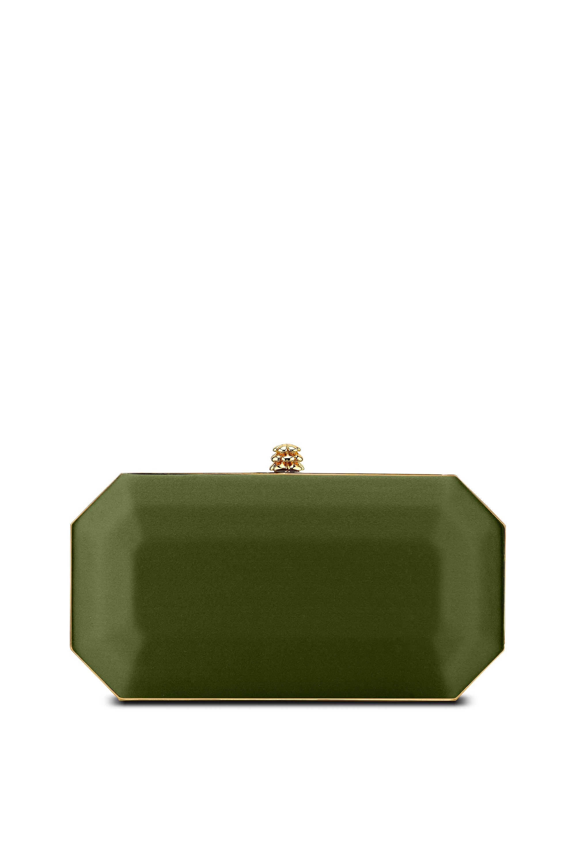 The Perry Small is featured in our Peridot satin with gold hardware. The Perry is a hard-framed clutch designed with interior pockets and an optional gold cross-body chain. It's elegant emerald shape is inspired by Tyler's own engagement ring and