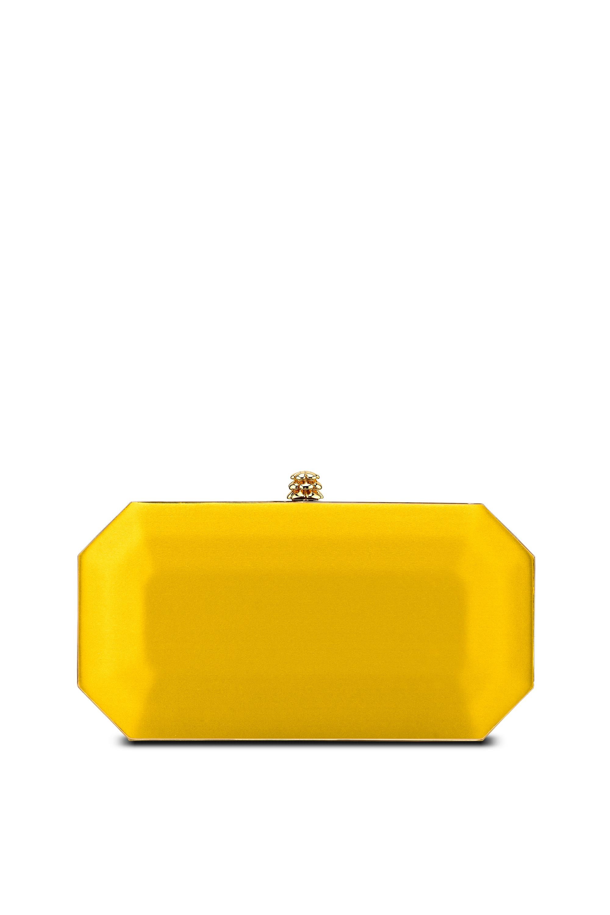 The Perry Small is featured in our Canary satin with gold hardware. The Perry is a hard-framed clutch designed with interior pockets and an optional gold cross-body chain. It's elegant emerald shape is inspired by Tyler's own engagement ring and