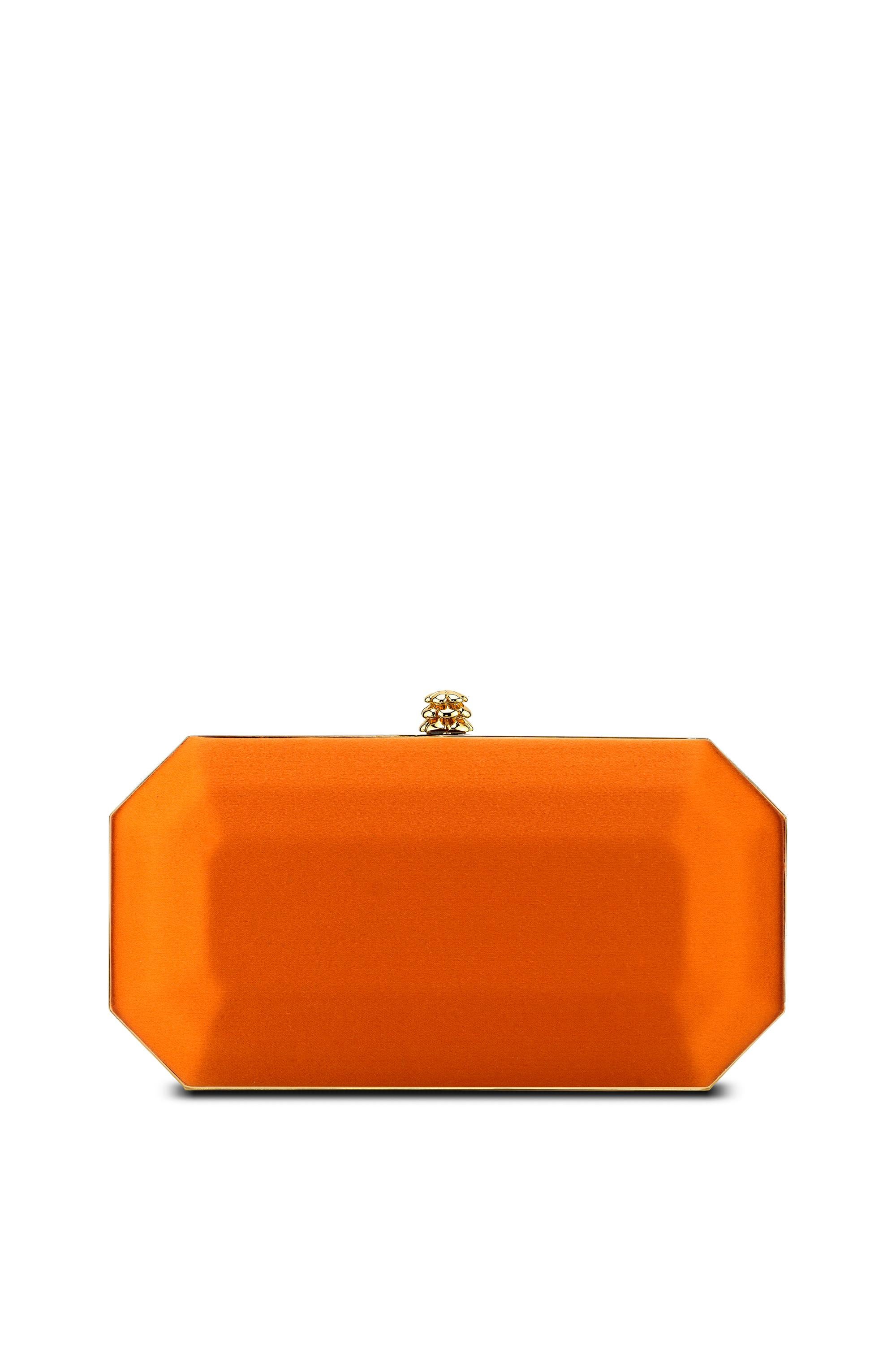 The Perry Small is featured in our Tiger Orange satin with gold hardware. The Perry is a hard-framed clutch designed with interior pockets and an optional gold cross-body chain. It's elegant emerald shape is inspired by Tyler's own engagement ring