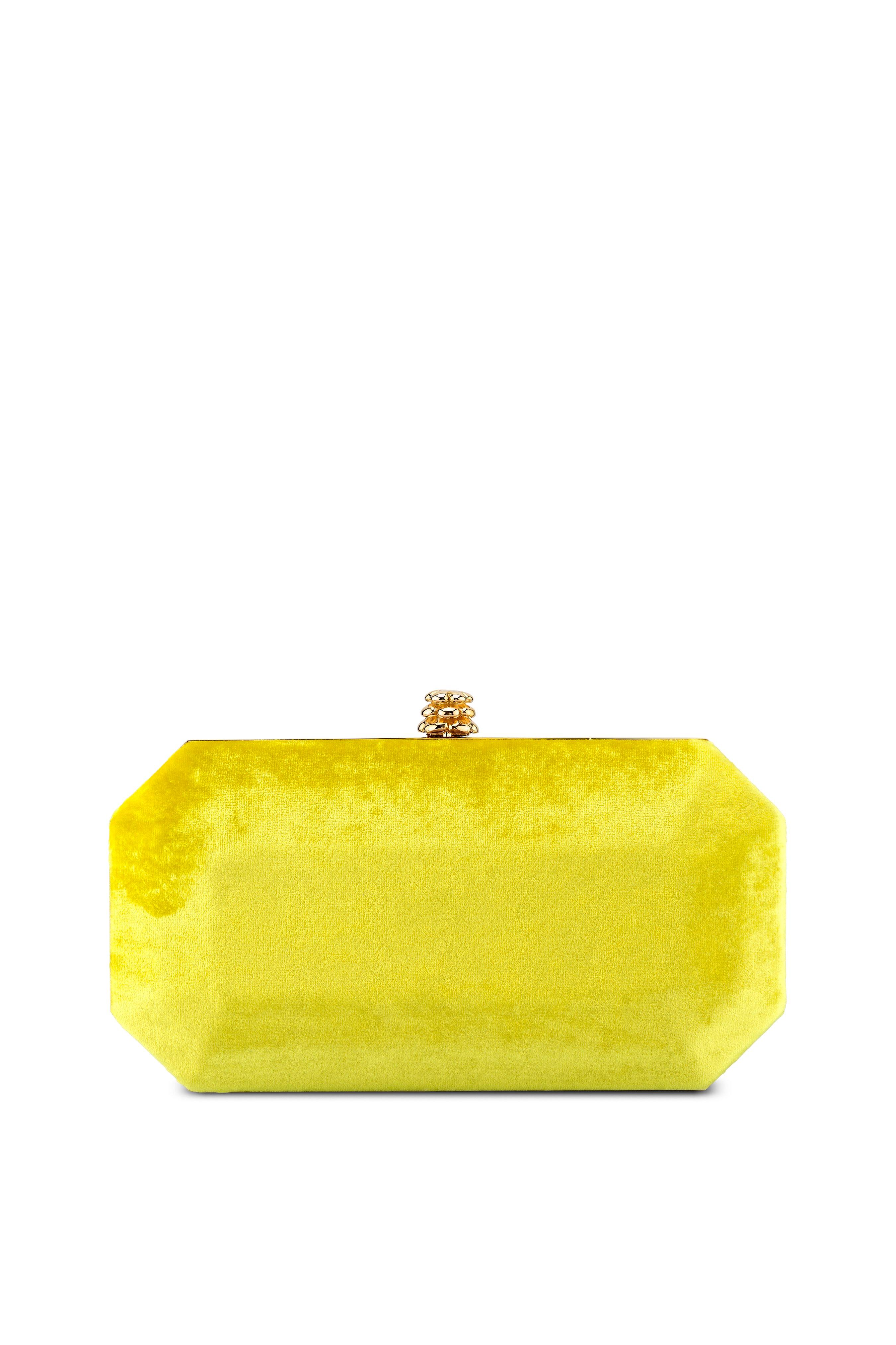 The Perry Small is featured in our Limoncello crushed velvet with gold hardware. The Perry is a hard-framed clutch designed with interior pockets and an optional gold cross-body chain. It's elegant emerald shape is inspired by Tyler's own engagement