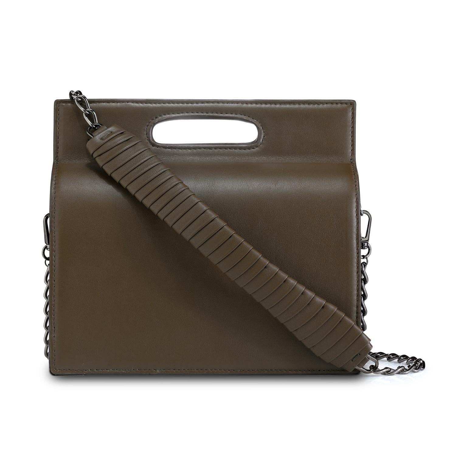 The Stella Handbag Tall is featured in Truffle Leather with gunmetal hardware. The Stella is a structured handbag with a magnetic closure and an optional cross-body chain with a leather-wrapped accent. It fits the large iPhone, has custom exterior