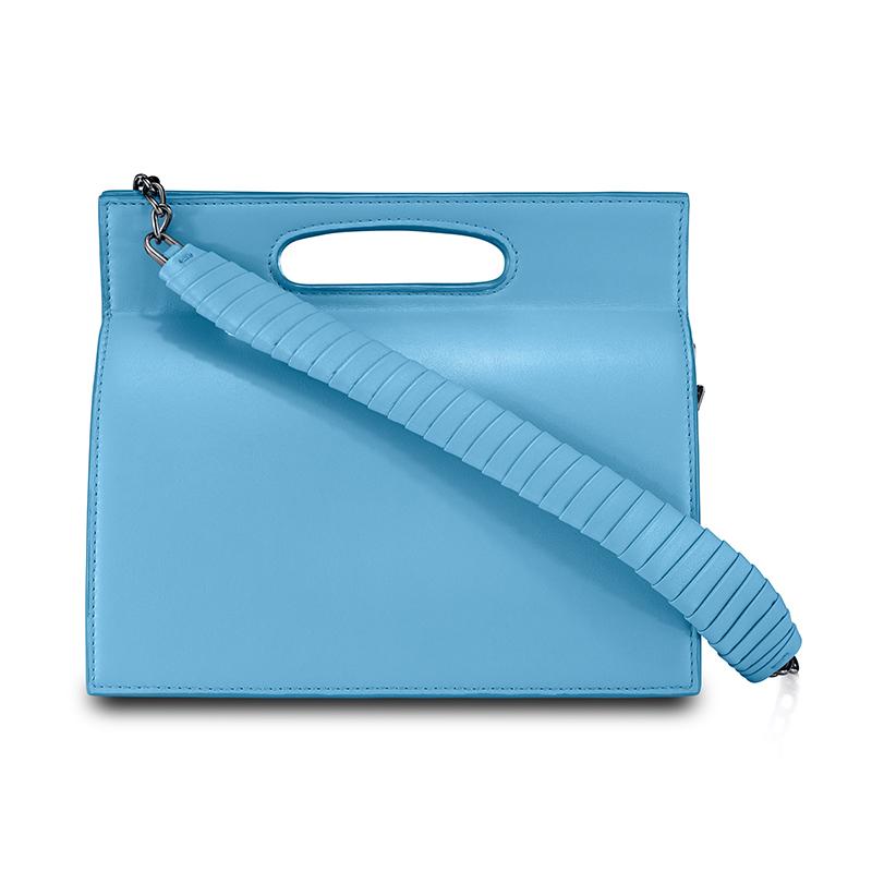 The Stella in Santorini Blue is a structured tri-compartment handbag with a magnetic closure and an optional gunmetal cross-body chain with a matching leather wrapped accent. It fits the large iPhone, has custom exterior metal detailing, interior