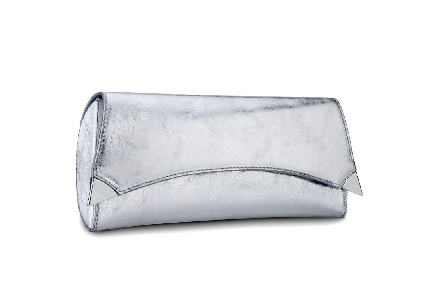 The Veronica in Chrome Antiqued Leather is designed with a three-quarter front flap and a magnetic snap closure. The clutch features a rounded back providing an extra spacious interior. It fits the large iPhone has a hidden back pocket, customized