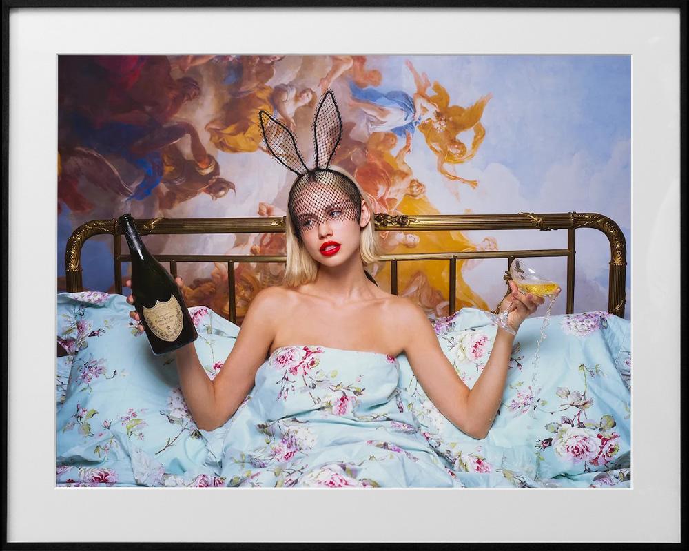 Tyler Shields Color Photograph - Bunny in bed with champagne