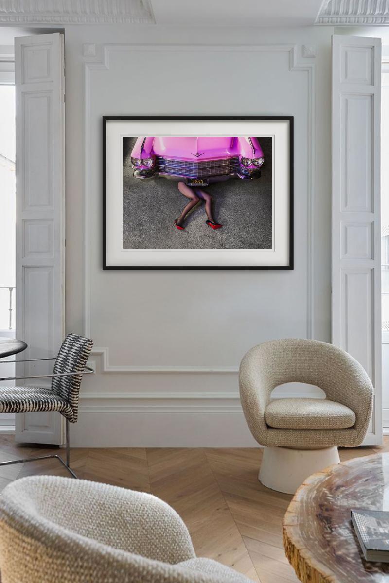 Cadillac Legs - Frau in Heels unter rosa Auto liegend, Kunstfotografie 2025 (Grau), Color Photograph, von Tyler Shields