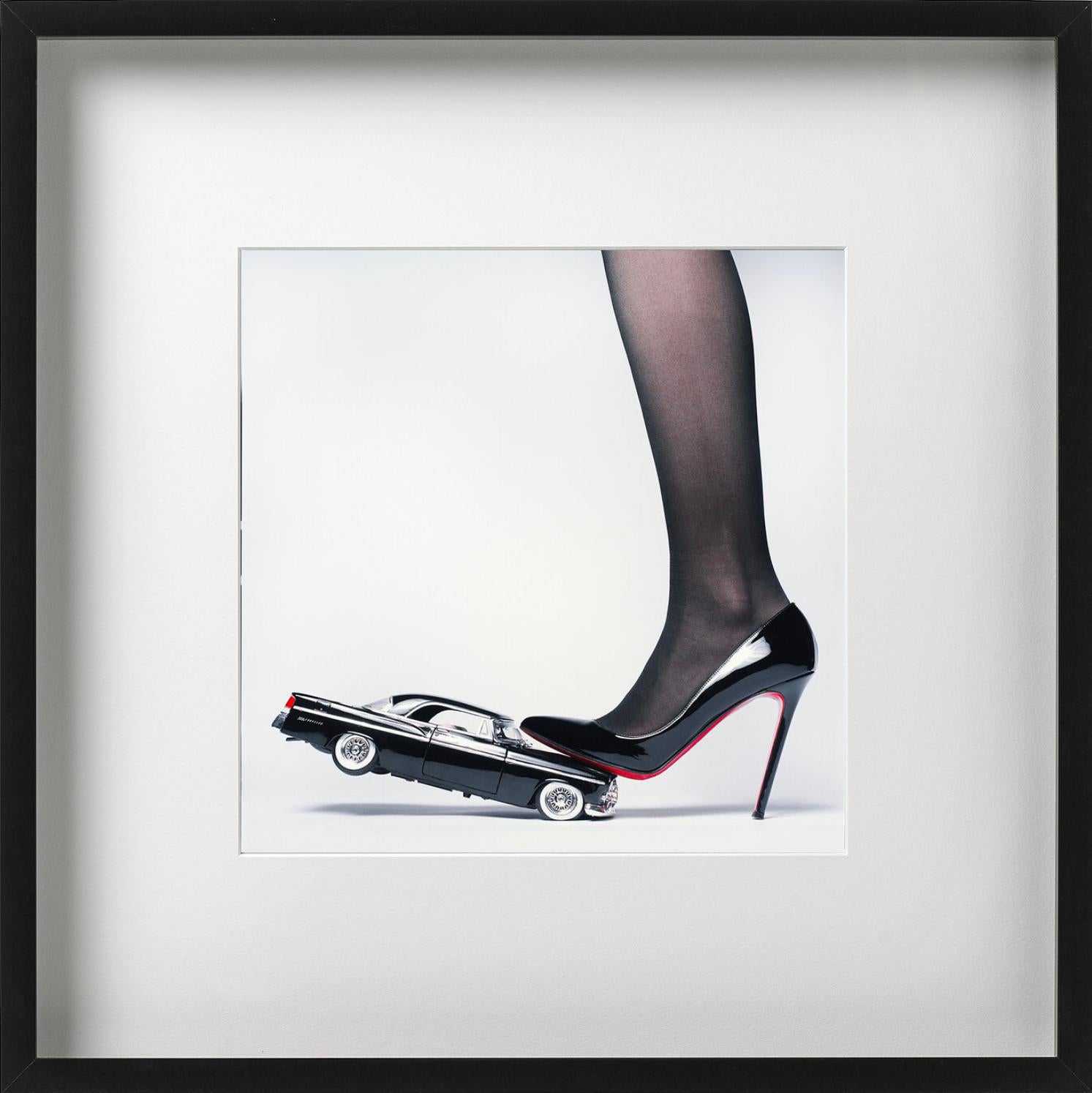 A Womans Foot in black stockings and High Heel crushing a Crysler Car, photographed by Tyler Shields. 

All prints are limited edition. Available in multiple sizes. High-end framing on request.

All prints are done and signed by the artist. The