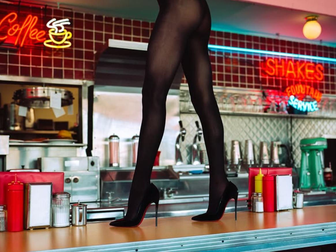Tyler Shields Figurative Photograph - Diner High Heels - Woman Walking on a Counter, Fine Art Photography, 2025
