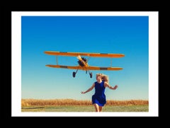 Tyler Shields - Girl Running From Plane, Photography 2015, Printed After