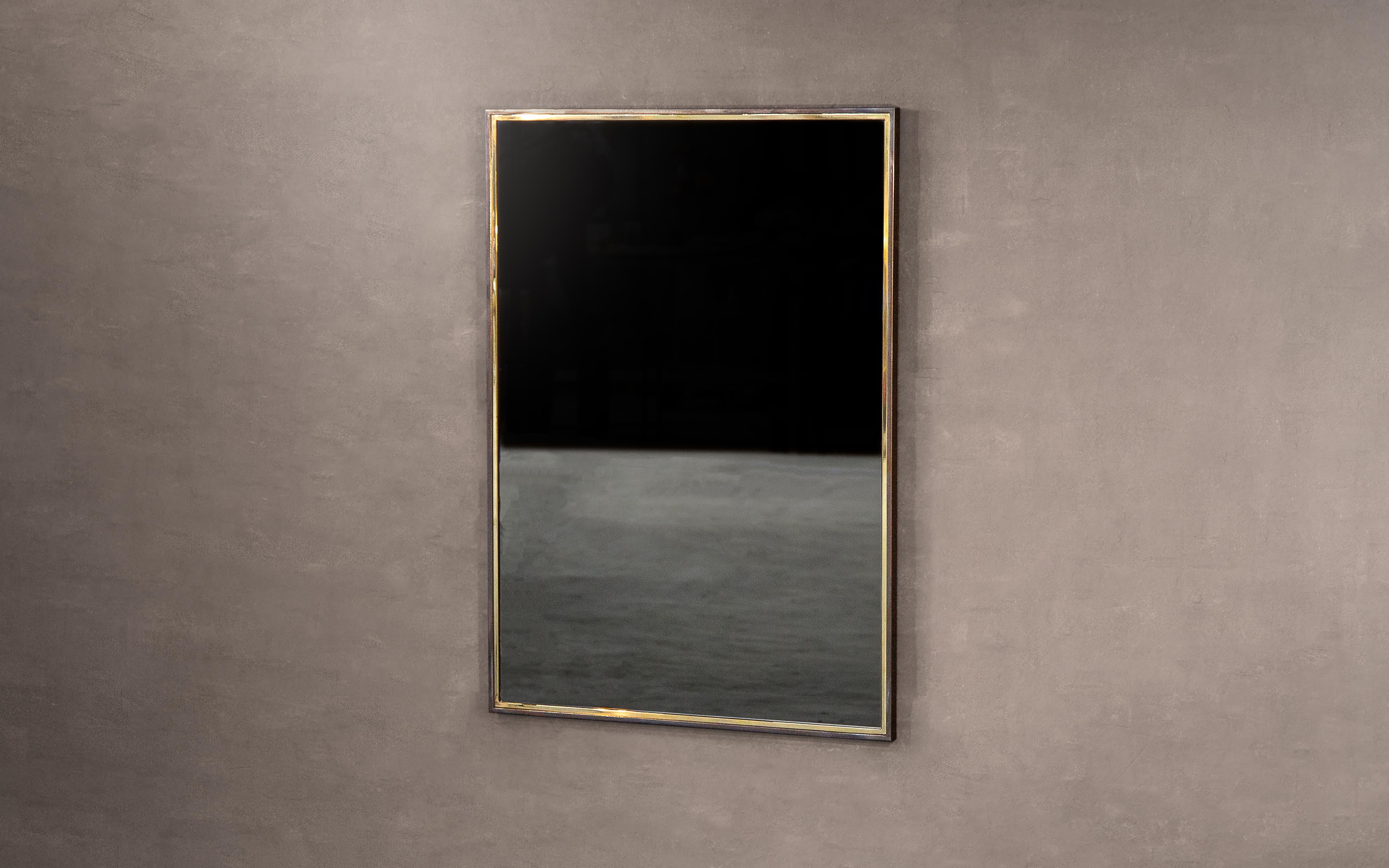 A dual-framed wall mirror in polished brass and blackened steel. Clear, bronze or grey tinted glass available. Supplied with two screw fixing points to rear face. Handcrafted in the North East, England.

Measures: 110 cm height x 80 cm width x 2.5