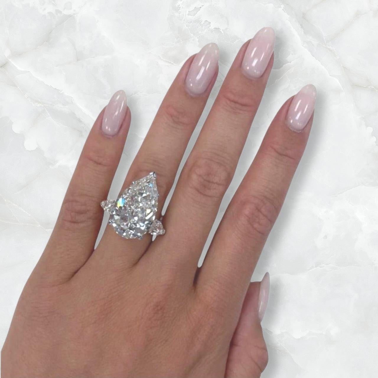 Stunning Type 2A Golconda GIA Certified 7.02 Carat Pear Cut Diamond Ring, meticulously set in luxurious platinum. Each side diamond features VVS clarity and D color, ensuring exceptional brilliance and radiance. This exquisite piece is perfect for