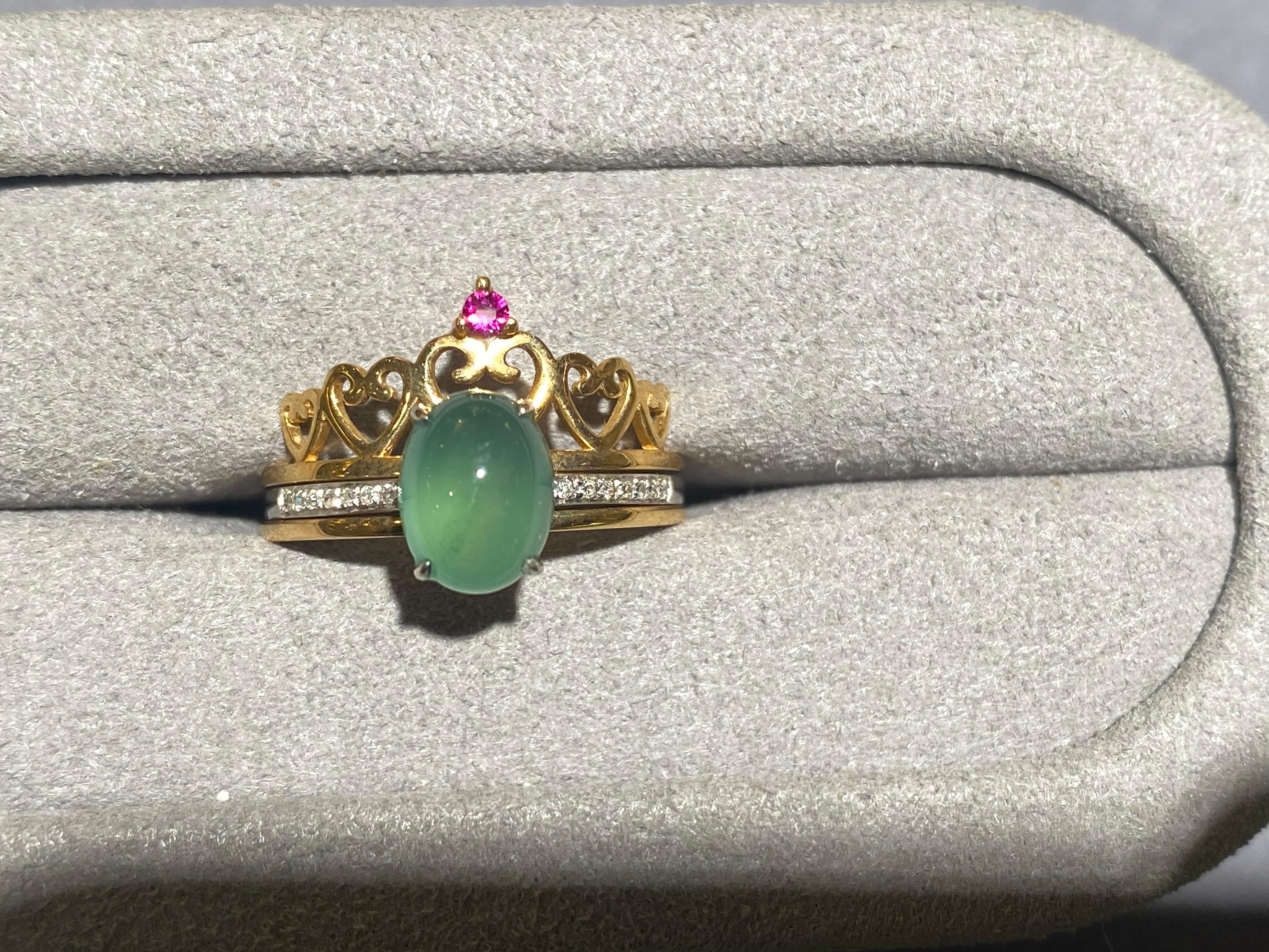 This is a type A green jadeite and diamond detachable ring in 18k yellow and white gold. The jadeite is set on the 18k white gold ring and approximately a quarter of the band of the ring is set with micro diamonds. The jadeite 18k white gold ring
