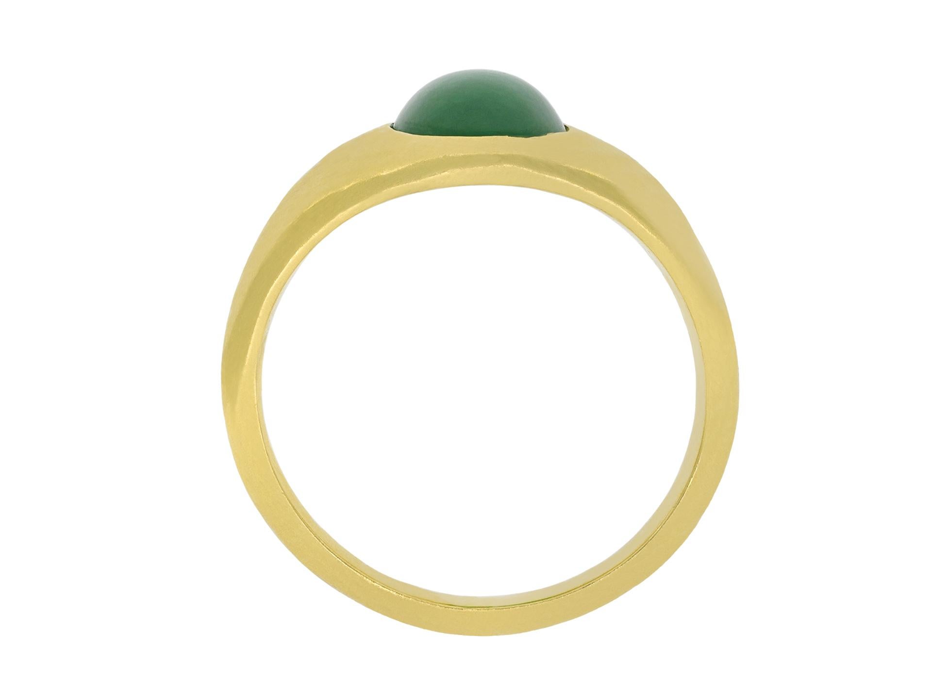 Type-A jade ring. Set to centre with an oval cabochon natural unenhanced Type-A jade in an openback rubover setting with a weight of 2.81 carats, to a solitaire design, featuring polished edges, a conforming gallery and oval open backholing, the