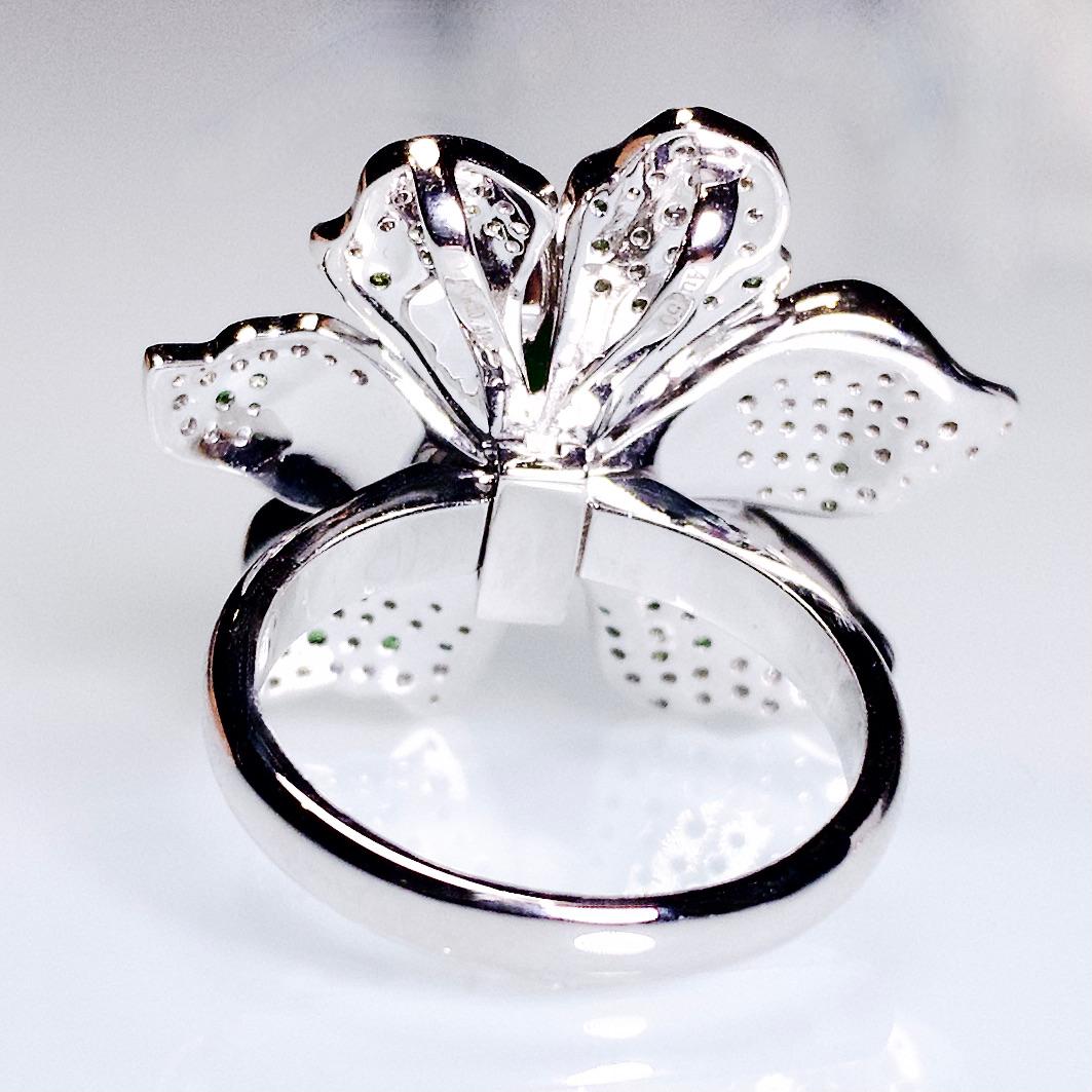 A Peony flower motif ring pendant i 18K White Gold. The vivid green Type A Jadeite cabochon is set in the middle of the peony flower motif surrounded by multiple shades of Tsavorite and Diamond pave. In order to make the peony looks realistic, the