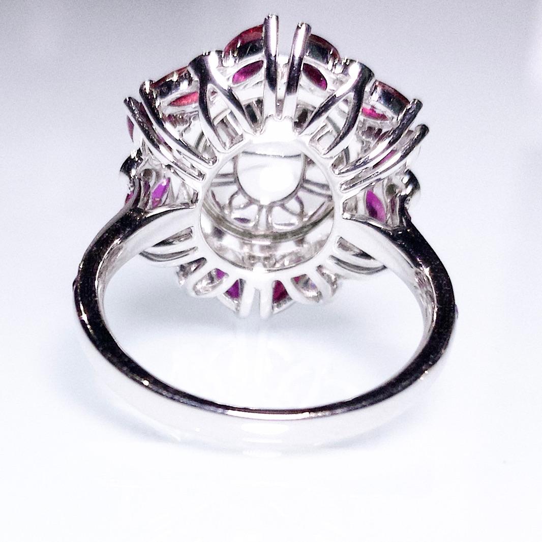 This is a flower motif Type A Jadeite, Ruby and Diamond ring in 18K White Gold. The almost transparent Jadeite is surrounded by a repetitive butterfly motif. The butterfly is made of 2 marquise ruby and a round diamond. Those butterflies look as if
