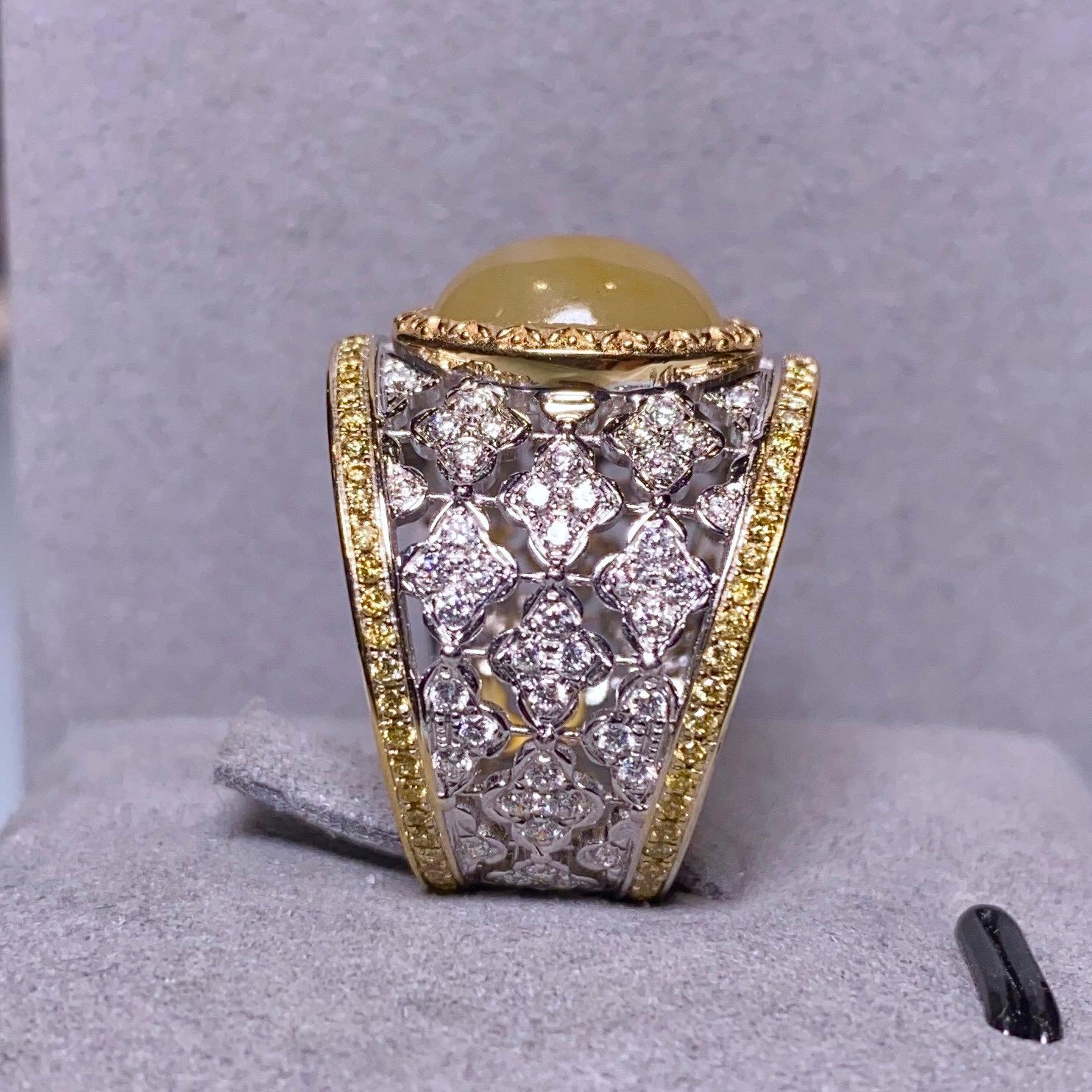 This is a big statement ring as it consist of a big Type A Yellow Jadeite. The Jadeite is surrounded by a circle of Yellow Gold. On the outer layer, there are multiple diamond encrusted flower motif which made up of the main body of the ring. The