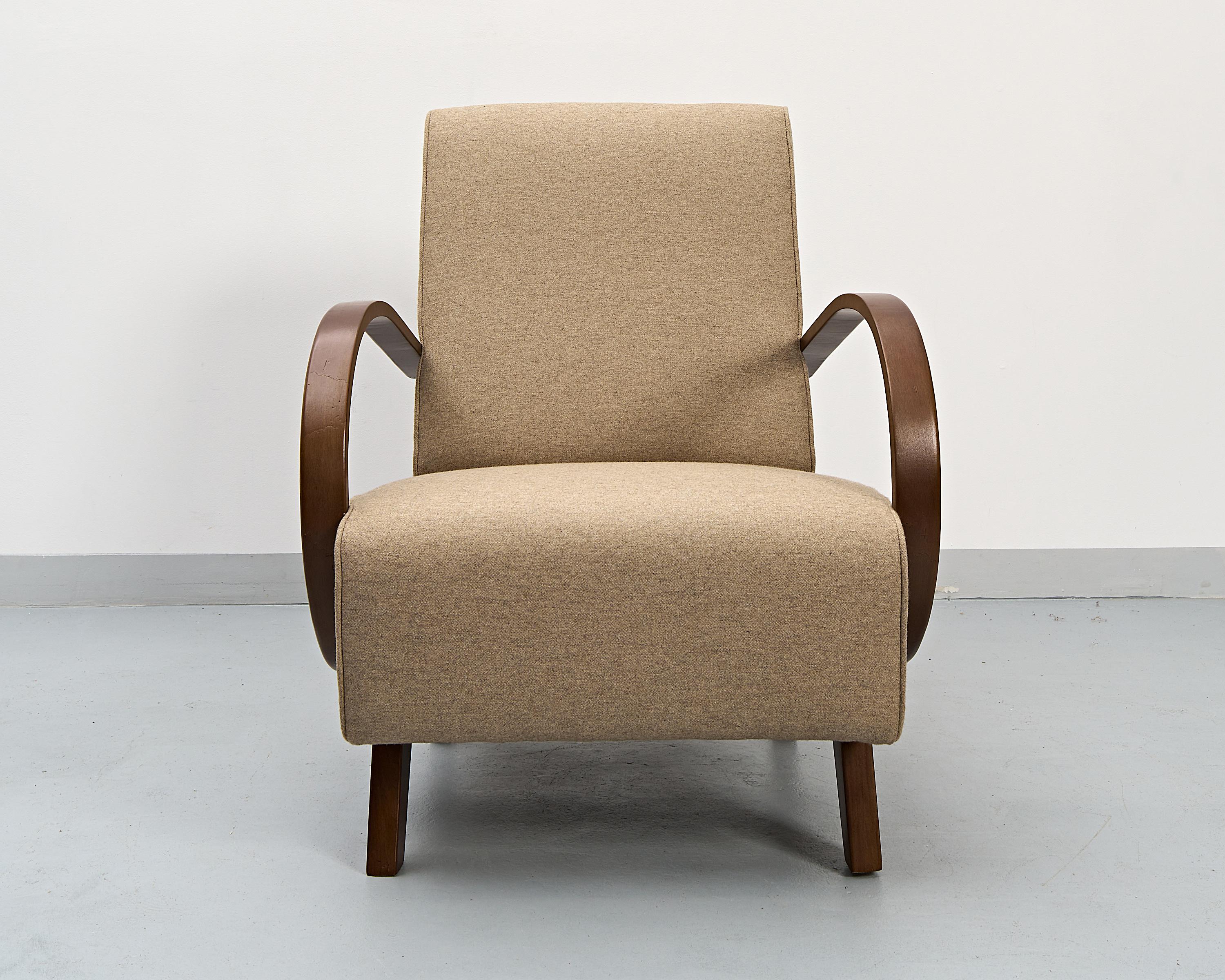 An armchair designed by the world famous Czech designer Jindřich Halabala. Produced during the 1930's.
Bent beechwood frame restored to half matt gloss. Seating recreated and covered in artificial wool fabric.
Beautiful restoration work.
