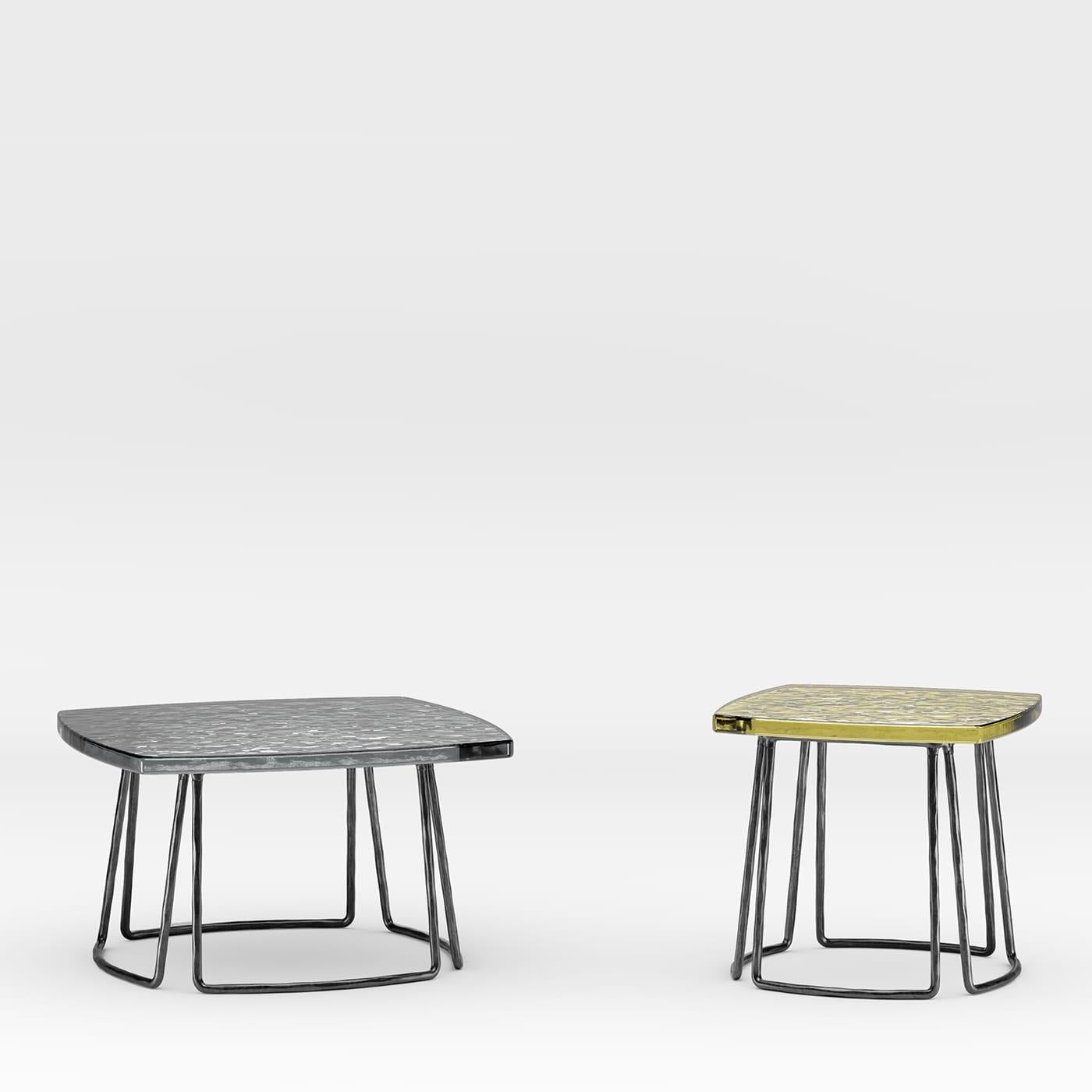 Designed by Stormo Studio for the superior crafting techniques of Dante Negro metalworkers, this side table combines a raw, handmade character with timeless sophistication. An elegant accent to an outdoor patio, it is made of stainless steel,