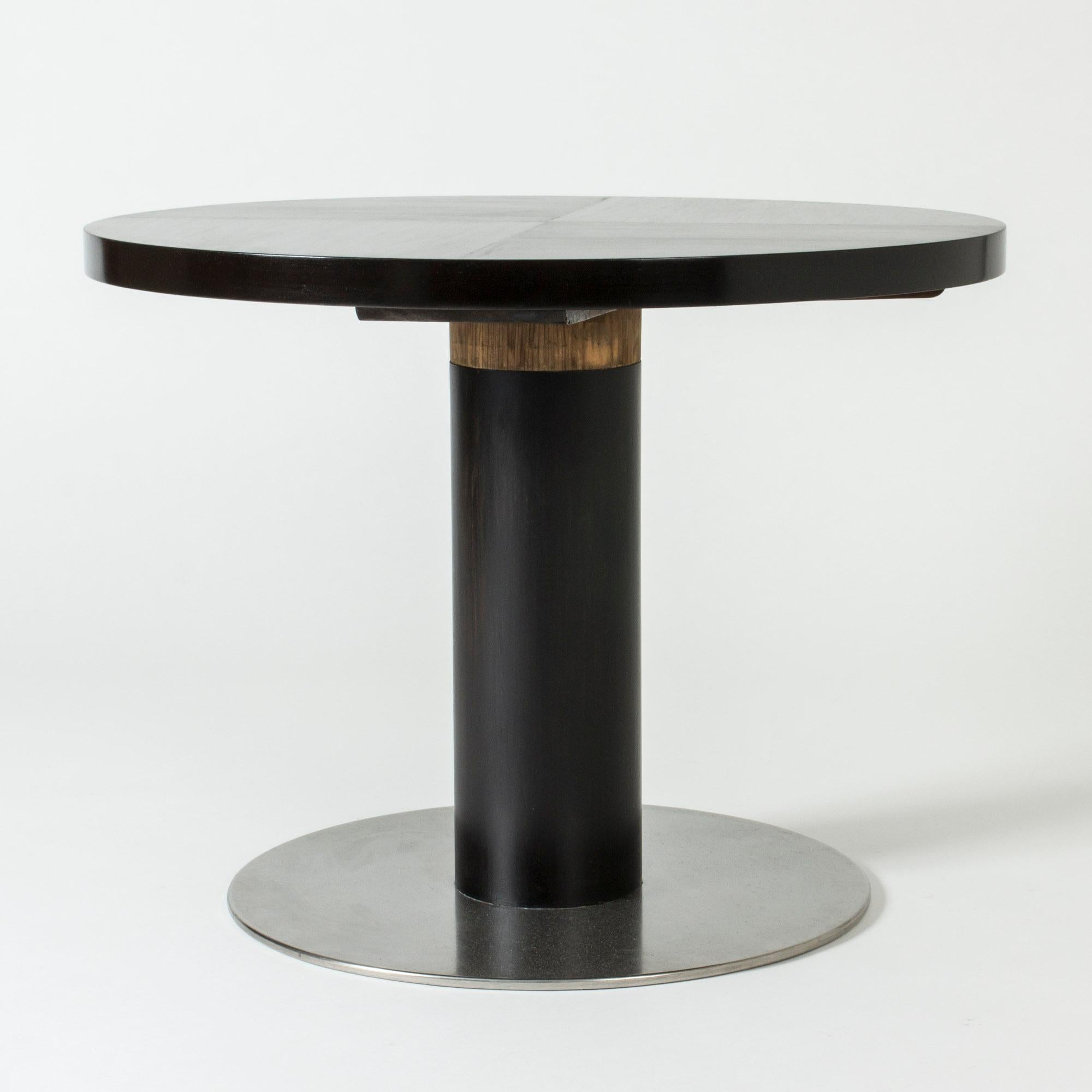 Round “Typenko” coffee or occasional table by Axel Einar Hjorth for NK. Striking in its simplicity, made from black lacquered birch with a stainless steel base.