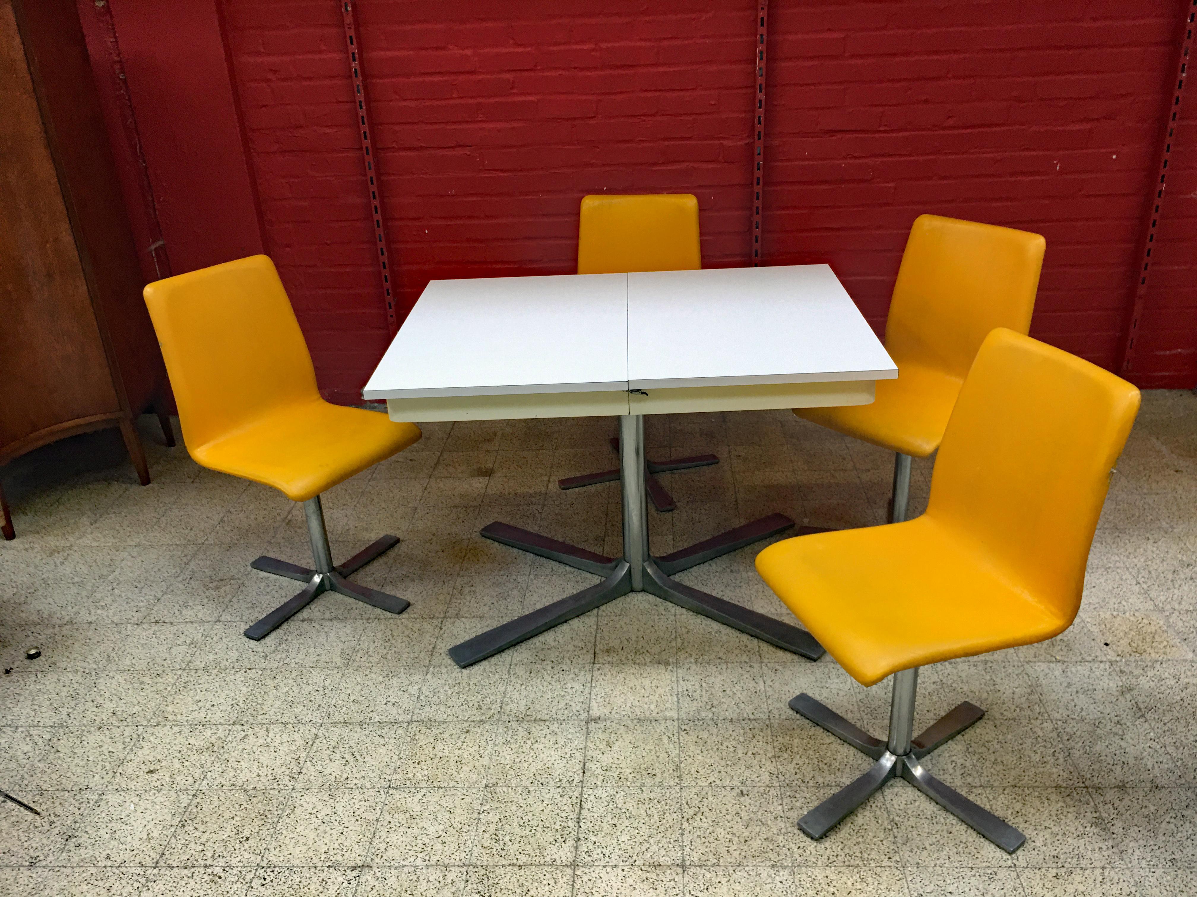 Typical French kitchen set from the 60s.
1 table with integrated extensions and 4 seats.
good general condition, worn seat upholstery 

Dimensions table closed : 76 x 110 x80 cm
Dimensions table opened : 76 x144 x 80 cm
Chairs : 86 x 40 x42 cm