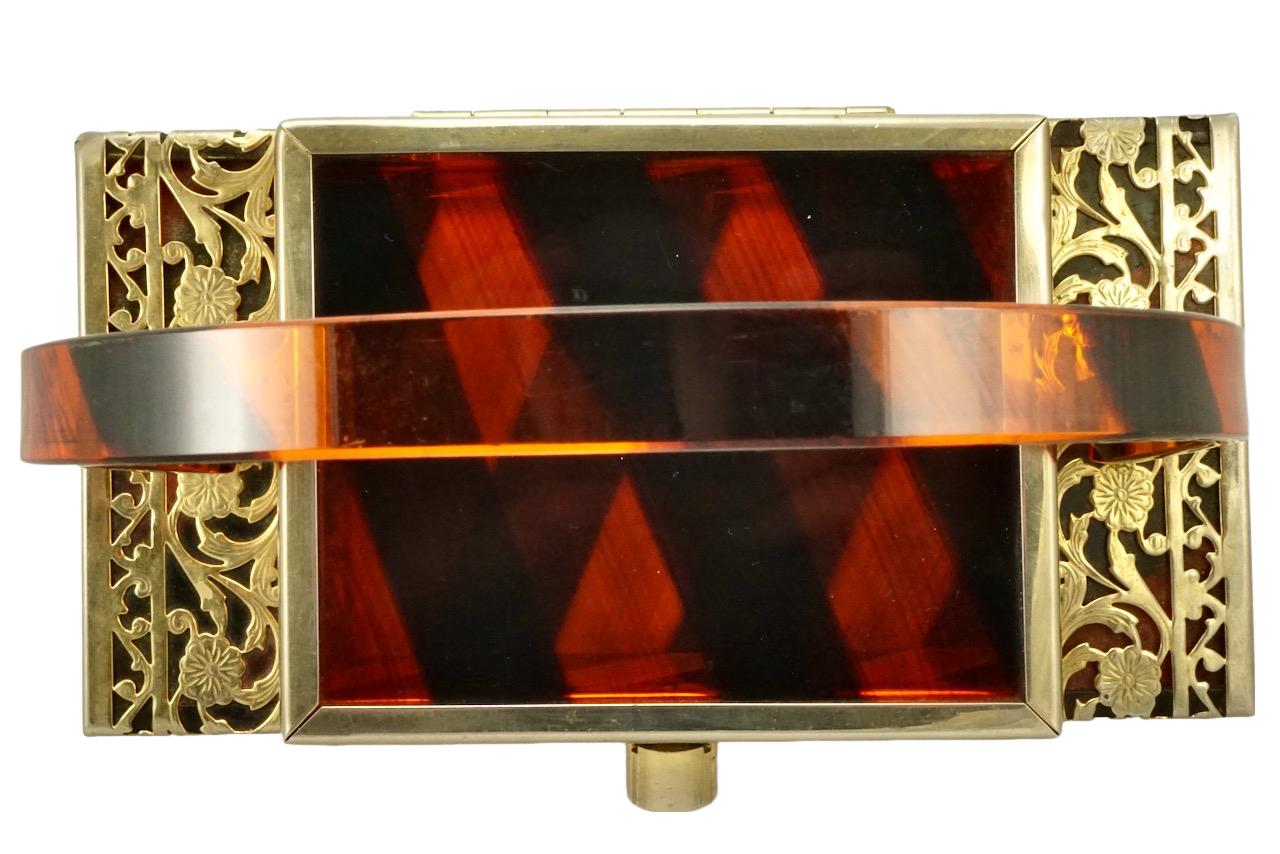 Wonderful Tyrolean New York black and orange striped lucite handbag, with gold tone filigree decoration. Measuring width 20 cm / 7.8 inches by maximum height 8.75 cm / 3.4 inches, and depth 10.2 cm / 4 inches. The handle drop is 16.5 cm / 5.49