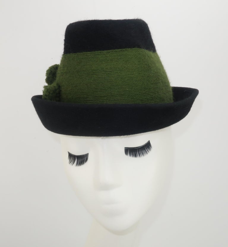 A Tyrolean style deep green mohair hat with olive green yarn 'band' and pom pom decoration accented by carved horn buttons.  The traditional Alpine look is by German hat company, Aurel Huber, and dates to the 1950's.  Very good vintage