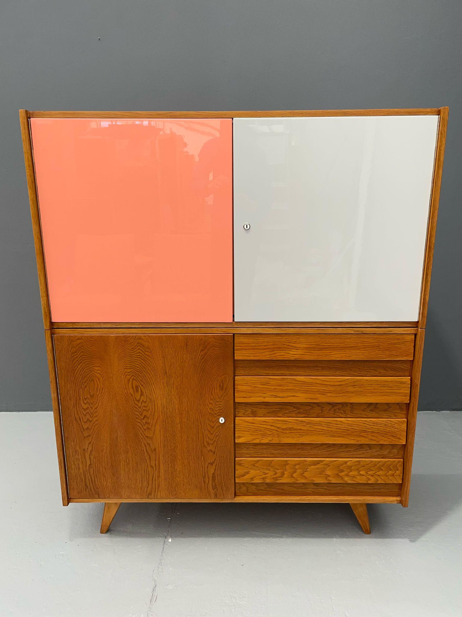  We offer this redesigned cabinet by noted Czech designer Jiří Jiroutek for the state enterprise Interiér Praha. This specific piece was manufactured in Plant No. 11 in Třešť and features lacquered doors in pastel pink and cream, combined with an