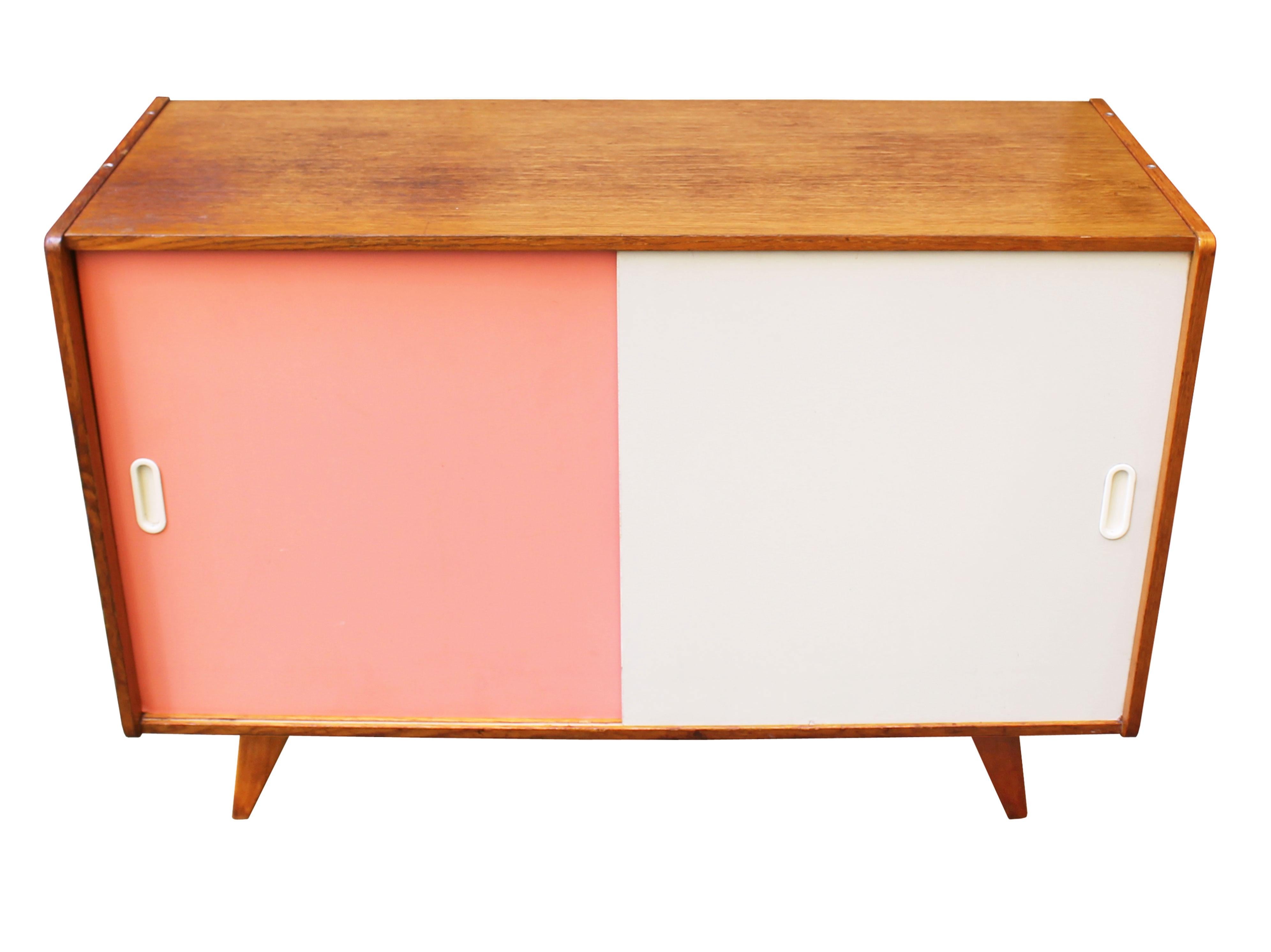 The U-452 Mid Century sideboard with pink and white sliding doors, was designed by the Czech furniture designer Jiri Jiroutek. It is part of the popular U collection manufactured by Interier Praha in the 1960s Czechoslovakia.

This piece perfectly