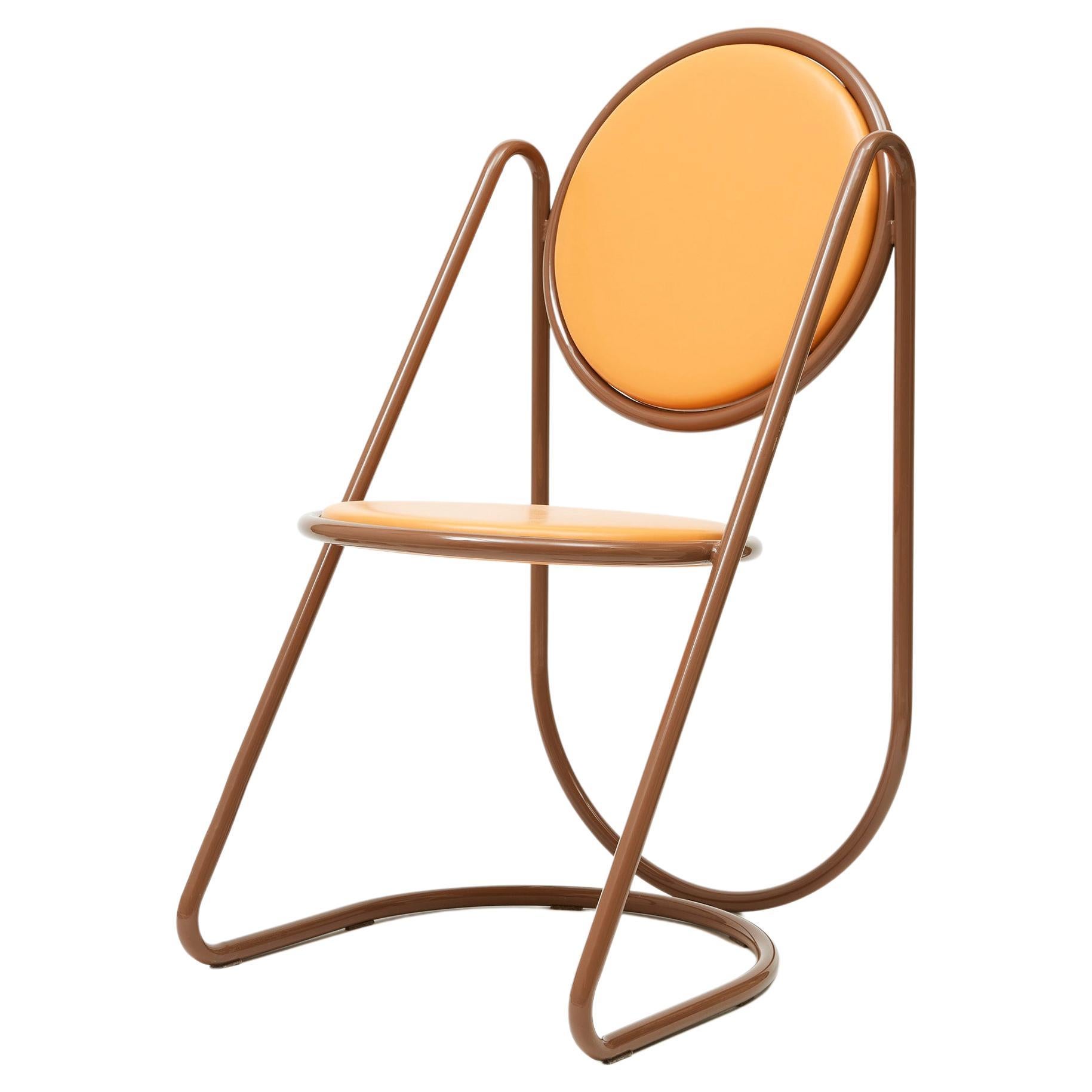 Dramatic and sculptural, this chair from the U-Disk Collection is sure to capture attention wherever it is placed. A natural addition to a retro-inspired decor, it consists of a continuous, cleverly bent tubular structure in brown-lacquered steel