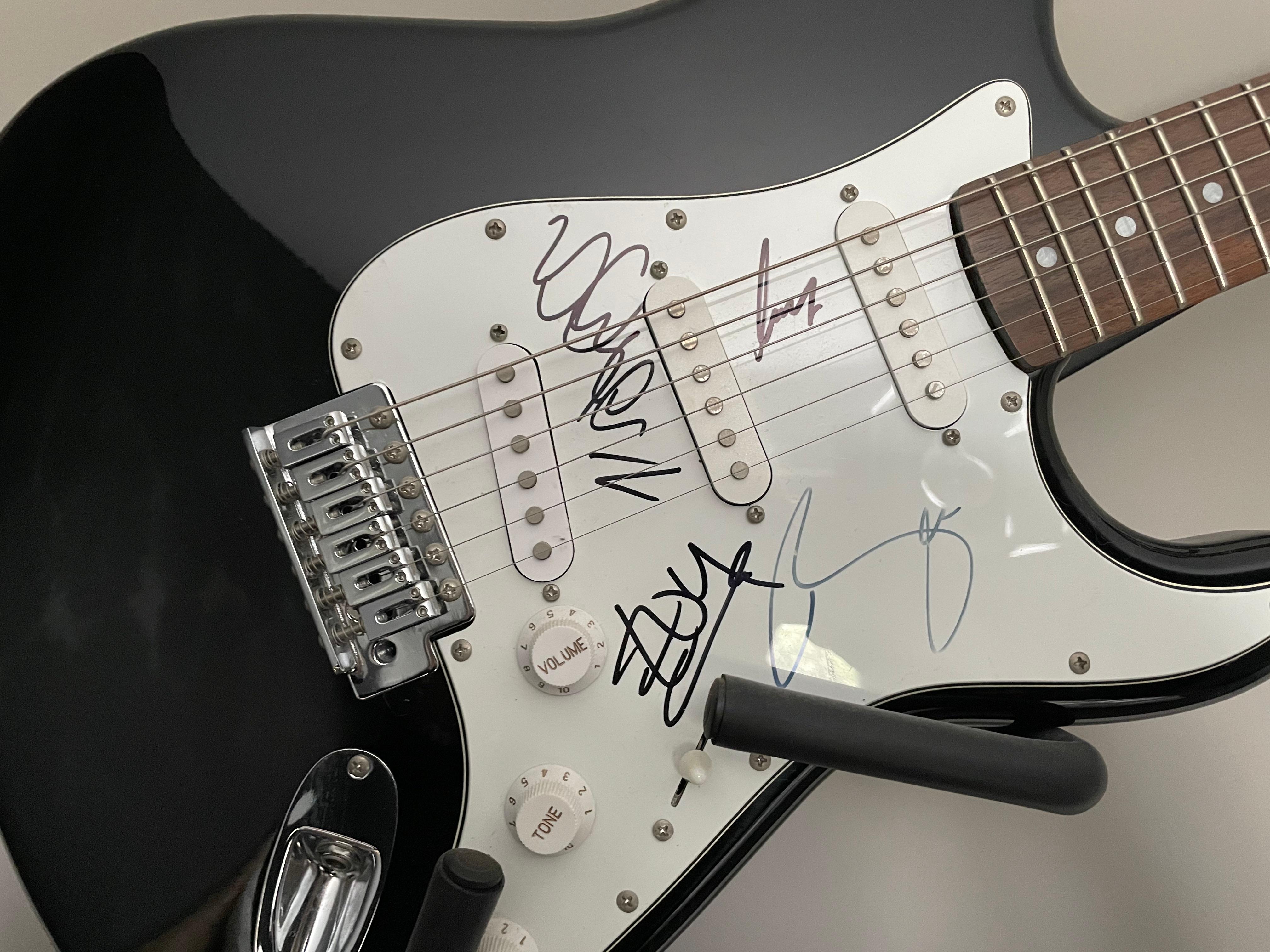 A U2 fully-signed crafter Cruzer electric guitar
A fully working black electric Crafter Cruzer guitar.

Autographed by all 4 members of U2; Bono (1960- ), The Edge (1961- ), Larry Mullen (1961- ) and Adam Clayton (1960- ) in bold black ink on the