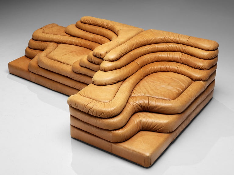 Ubald Klug for De Sede, pair of DS-1025 'Terrazza' landscape elements, in cognac leather, Switzerland, 1970s. 

Waterfall shaped sofa in cognac leather by the Swiss manufacturer De Sede. The design for this sofa was inspired by mountains and