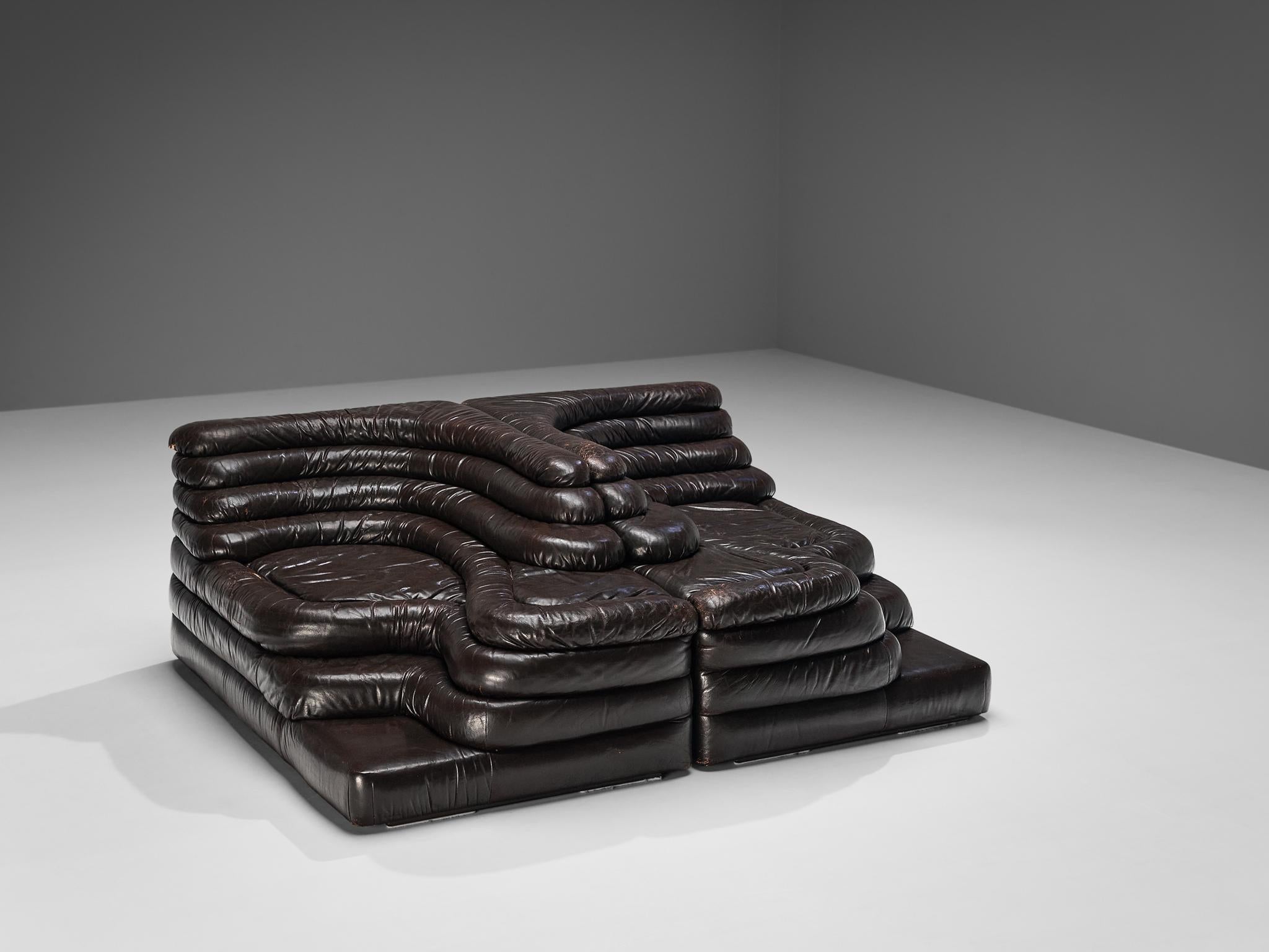 Ubald Klug for De Sede, pair of DS-1025 'Terrazza' landscape sofa elements, patinated brown leather, Switzerland, 1970s. 

Waterfall shaped sofas in a heavily patinated leather by the Swiss manufacturer De Sede. The design for this sofa was