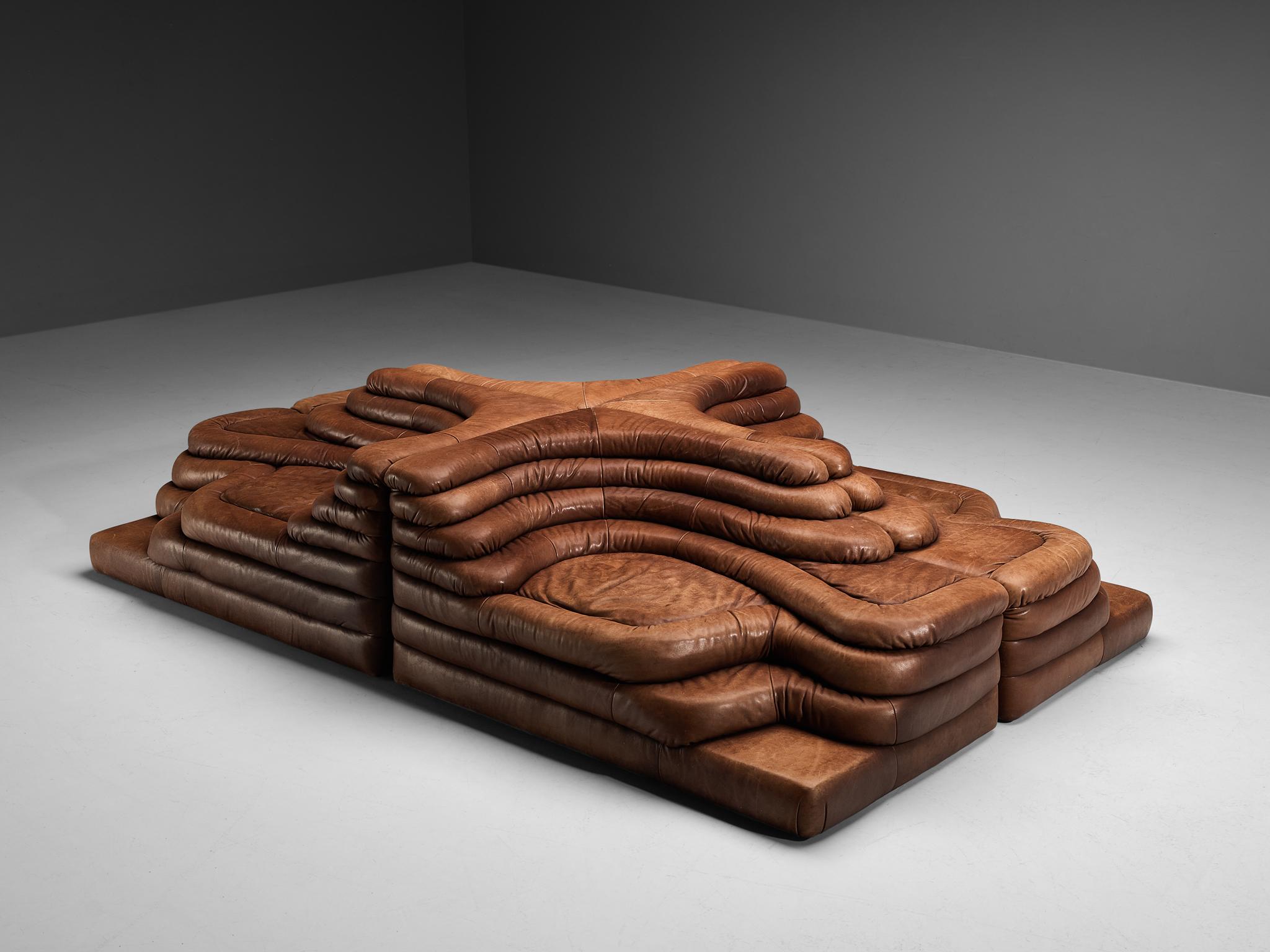 Ubald Klug for De Sede, set of four DS-1025 'Terrazza' landscape elements, in cognac leather, Switzerland, 1970s. 

Waterfall shaped sofa's in cognac leather by the Swiss manufacturer De Sede. The design for this sofa was inspired by mountains and