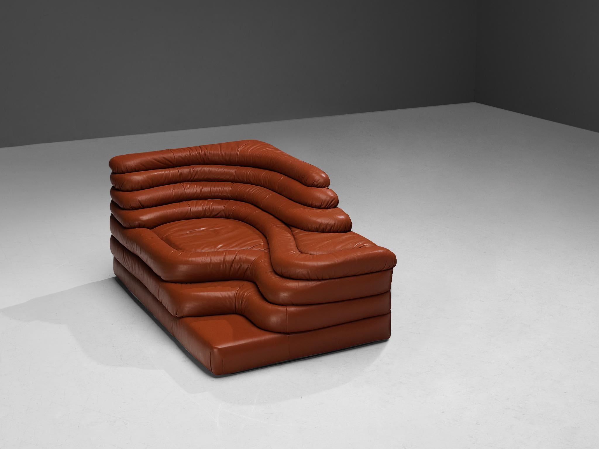 Ubald Klug for De Sede, DS-1025 'Terrazza' landscape sofa, in red leather, Switzerland, 1970s. 

Waterfall shaped sofa in red brown leather by the Swiss manufacturer De Sede. The design for this sofa was inspired by mountains and especially the