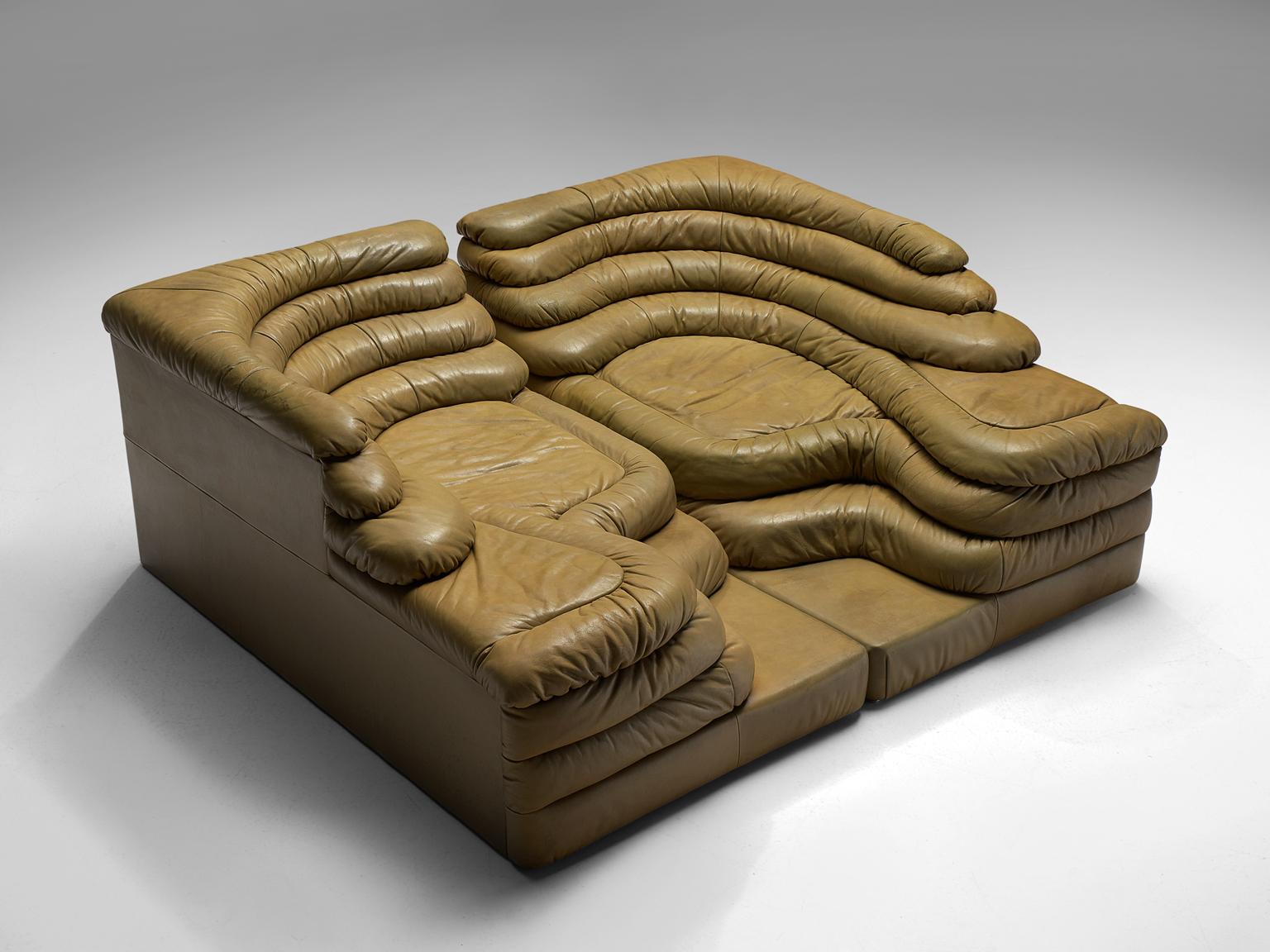 Ubald Klug for De Sede, two DS1025 'Terrazza' landscape elements, green brownish quality leather, by Switzerland, 1970s. 

This waterfall shaped sofa in light brown to green leather is designed by the Swiss manufacturer De Sede. The design for