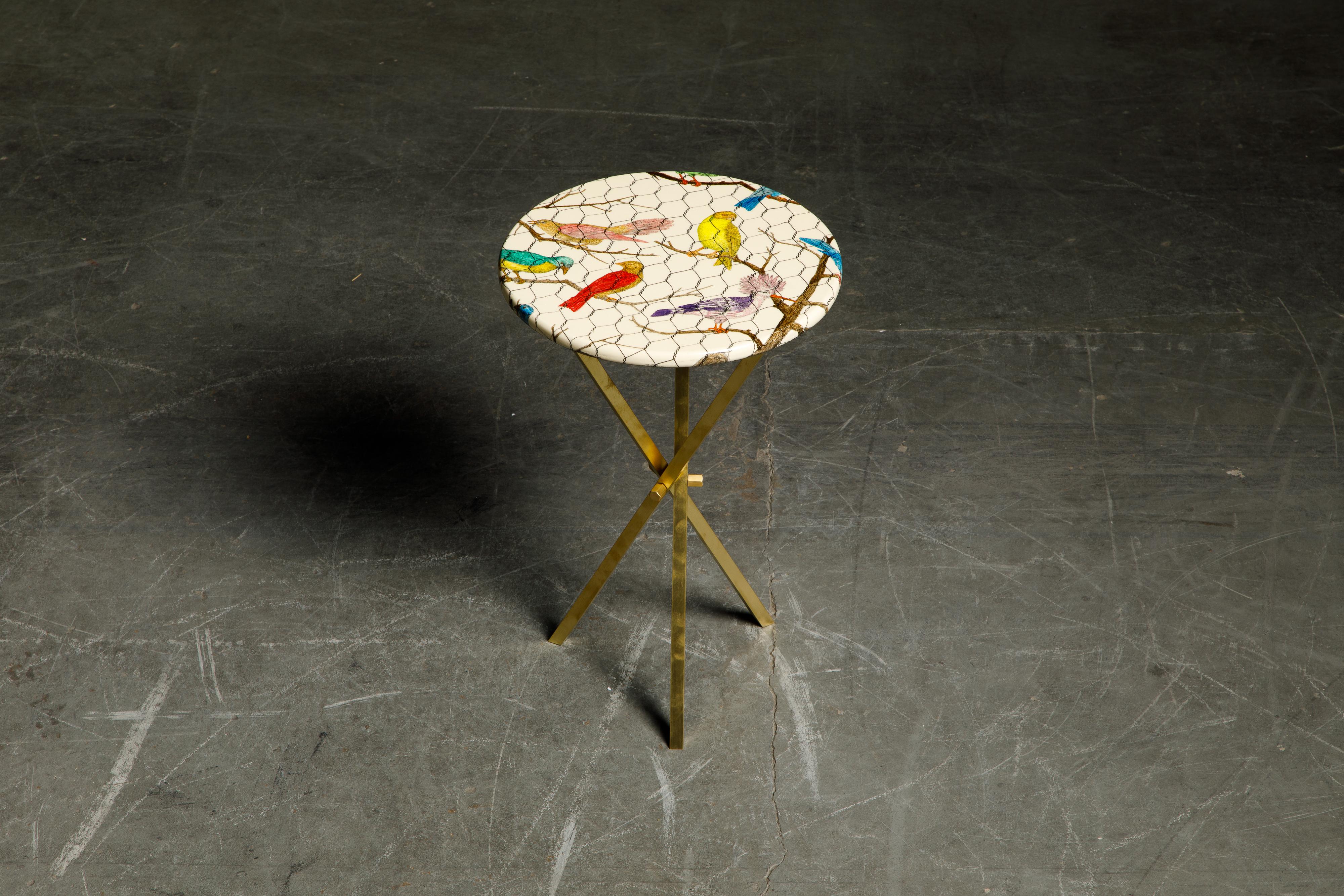 This gorgeous collectors item is a 'Uccelli Nella Gabbia' (Caged Birds in Italian) side table by Piero Fornasetti, signed underneath with its original label. This side table is made with lacquered wood that has birds within a wired cage over white