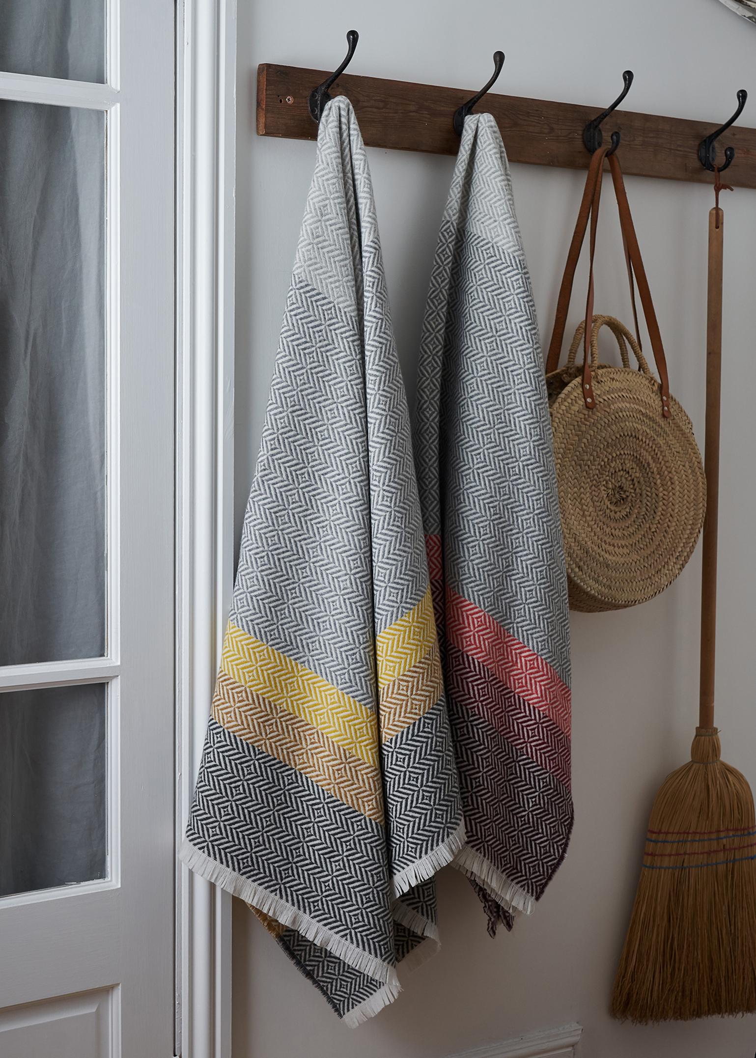Drawing inspiration from the color and pattern found in stain glass work, the Uccle block throw takes its name from an area of Brussels renowned for its Art Deco architecture.

Woven in blocks of grey and pearl grey melange with a deep border of