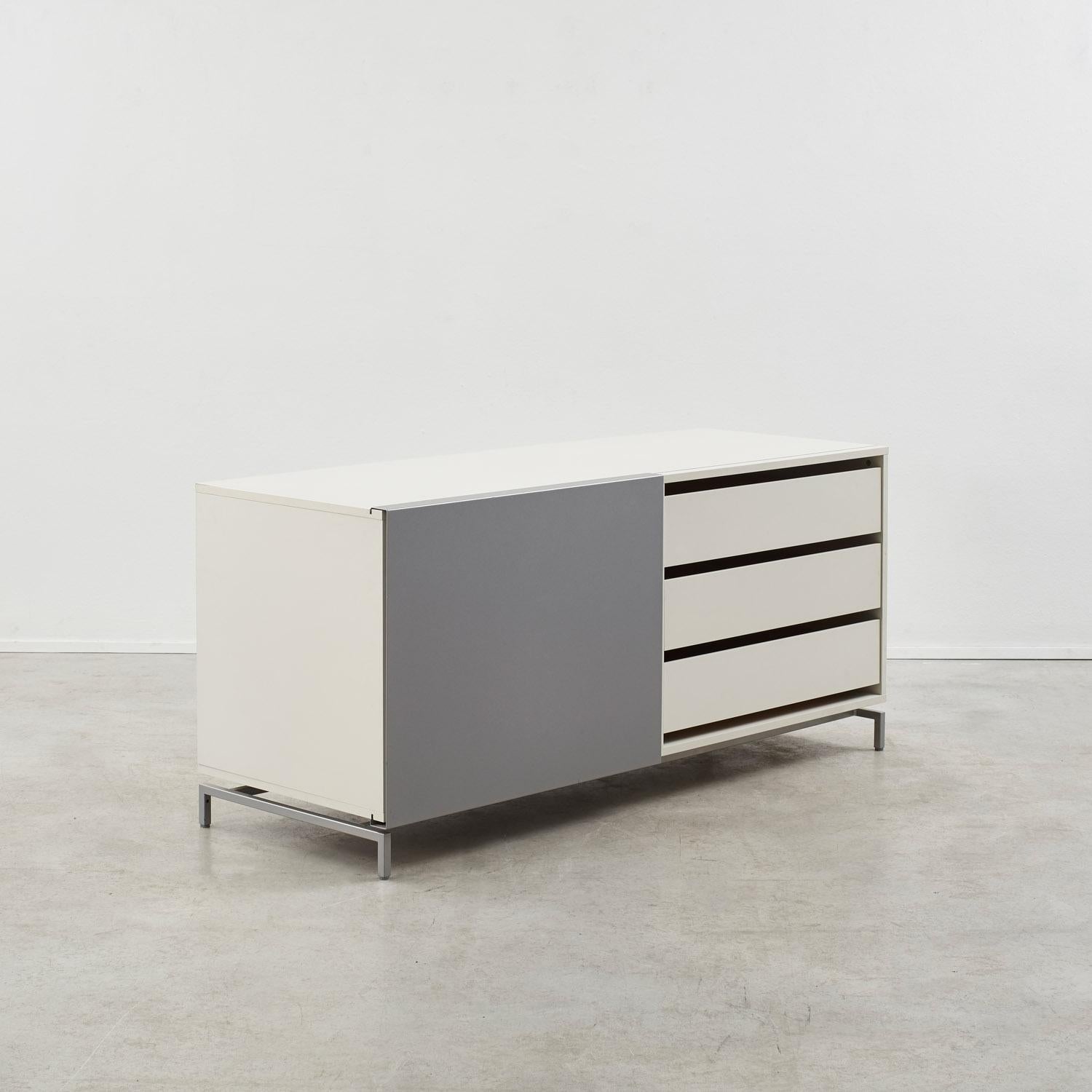 Shigeru Uchida reinterprets the traditional Japanese shoji screen in the Slide sideboard, where a gliding aluminium door moves across white MDF cabinetry. Resting on four slender metal legs, the piece carries a lightness and a Modernist sensibility.