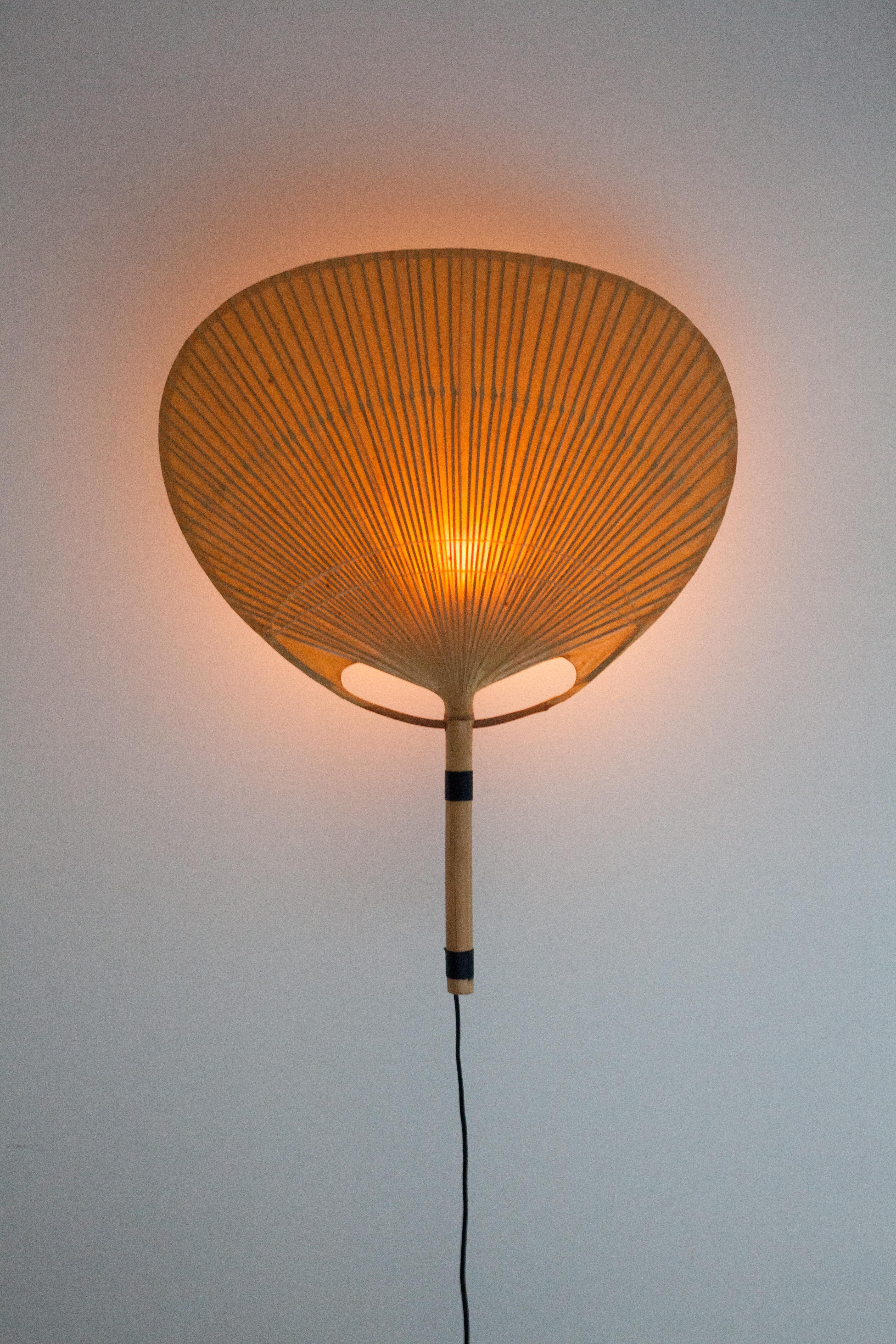 Iconic bamboo fan sconce by Ingo Maurer, Germany, 1079s. 

The Uchiwa fans are traditional Japanese hand fans and Maurer applied the same paper and bamboo techniques to create his wall sconces.