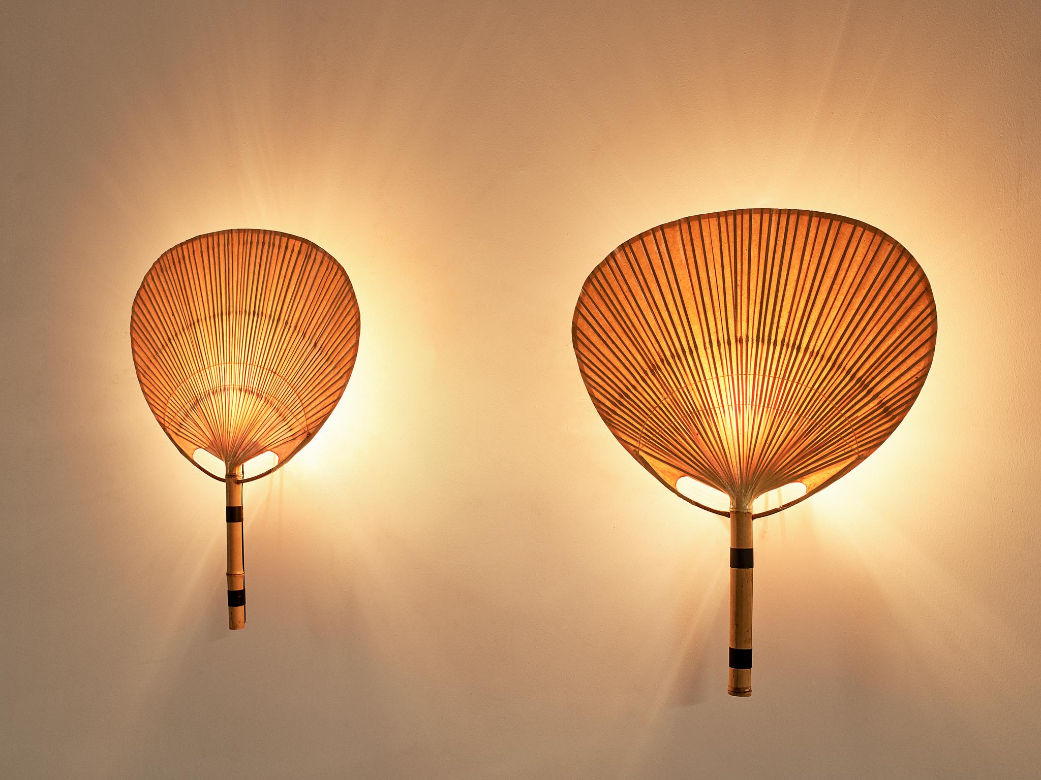 Ingo Maurer for M design, pair of 'Uchiwa III' wall lights, bamboo, ricepaper and wicker, Germany, 1973.

An refined set of two wall lights by Ingo Maurer, executed in bamboo and rice paper. Maurer was fascinated by the phenomenon of light and was