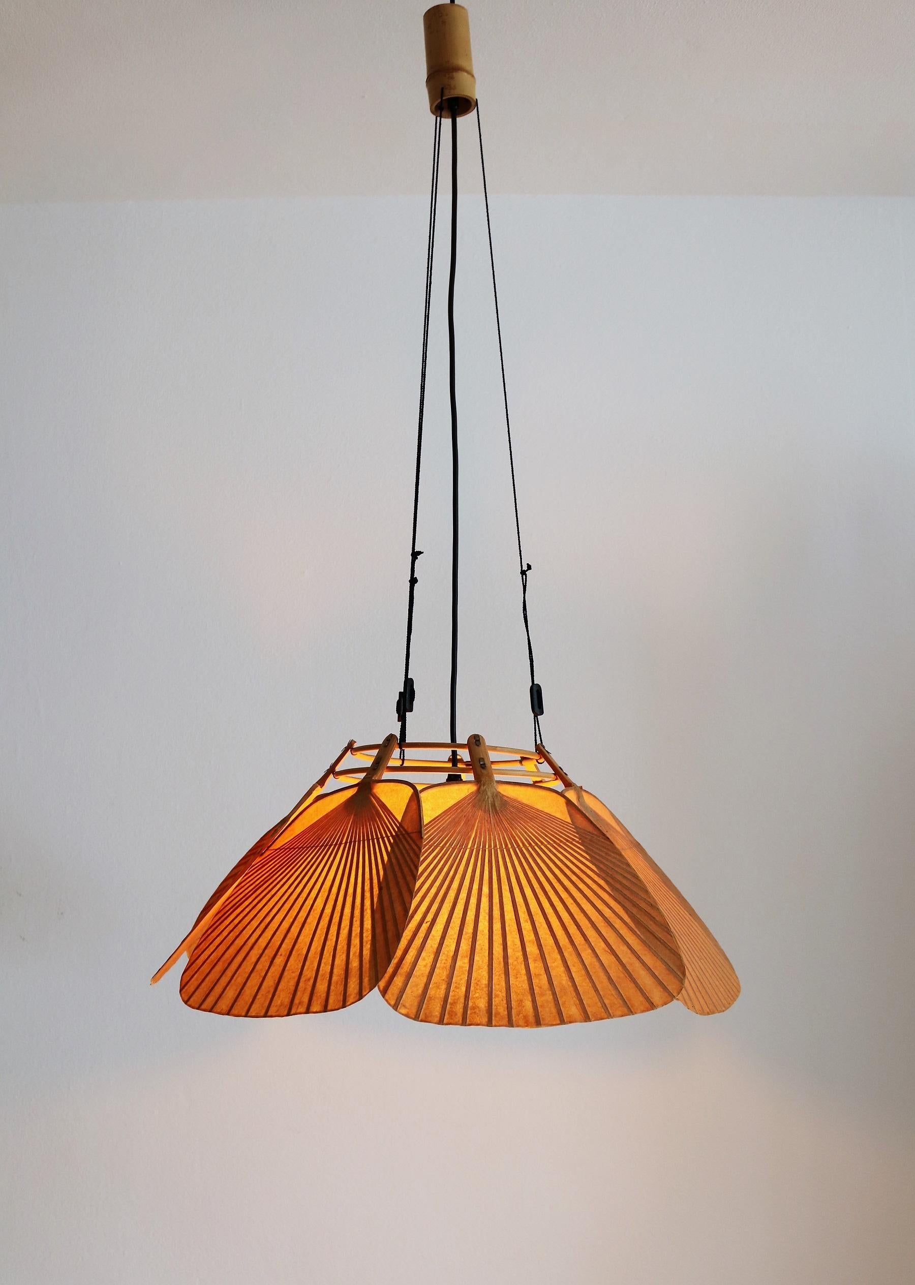 Beautiful and rare lamp named Shichi made of seven delicate fans which are made of bamboo and rice paper, designed from Ingo Maurer, 1973.
It makes beautiful natural light, depending also from the used light bulb.
The seven fans are attached with